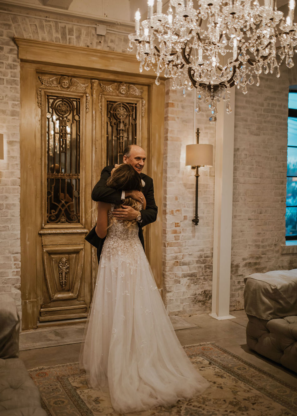 The bride hugs her dad in the bridal suite before she celebrates her love story at The Astorian in Houston, TX.