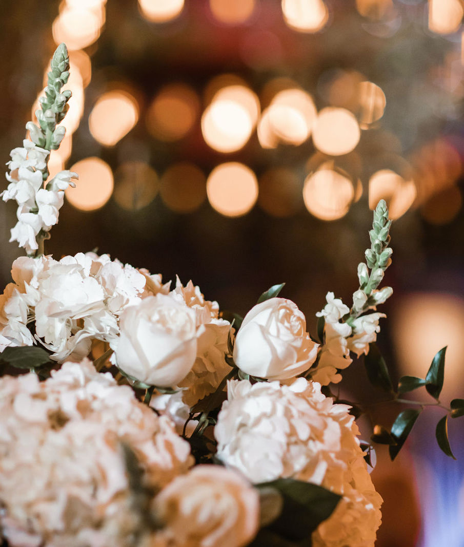 An up-close photo of an all-white flower arrangement set up for a wedding at The Astorian in Houston, TX. 