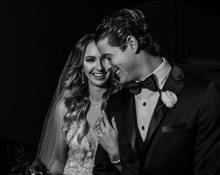 A black and white photo of Texas Rangers MLB player Nick Solak with his wife at The Astorian in Houston, Texas.