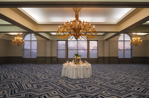 A reception table is set up in a ballroom at the Hilton Houston North hotel.