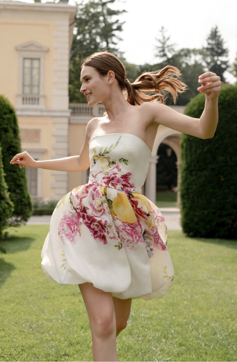 White bridal shower strapless dress with yellow, pink and green flower design by Monique Lhuillier. 