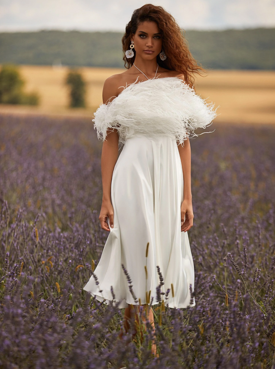 A white flowy midi dress with a feather top for brides from Alamour the label.