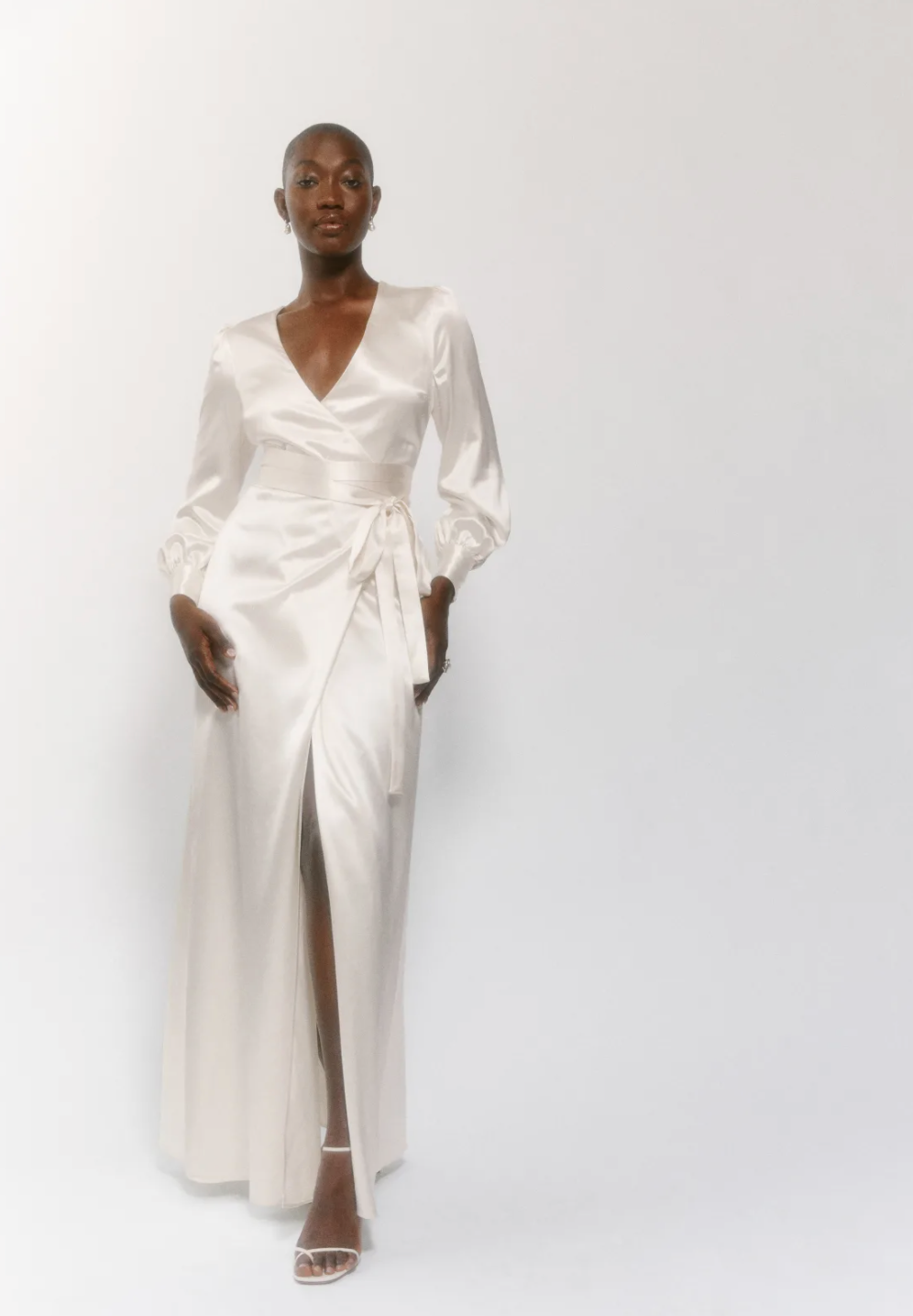 A white silky wrap dress with long sleeves and cuffs sold at Reformation for brides for their bridal shower.