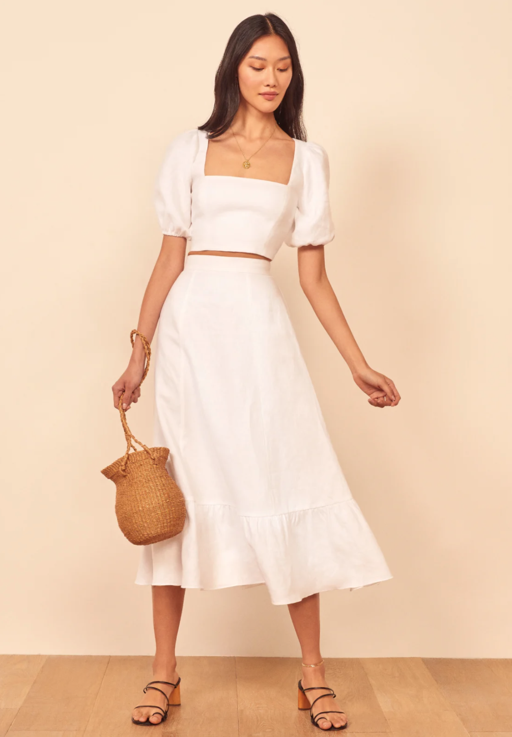 A white two-piece set with a midi skirt and a puff-sleeve top for a bride from Reformation.