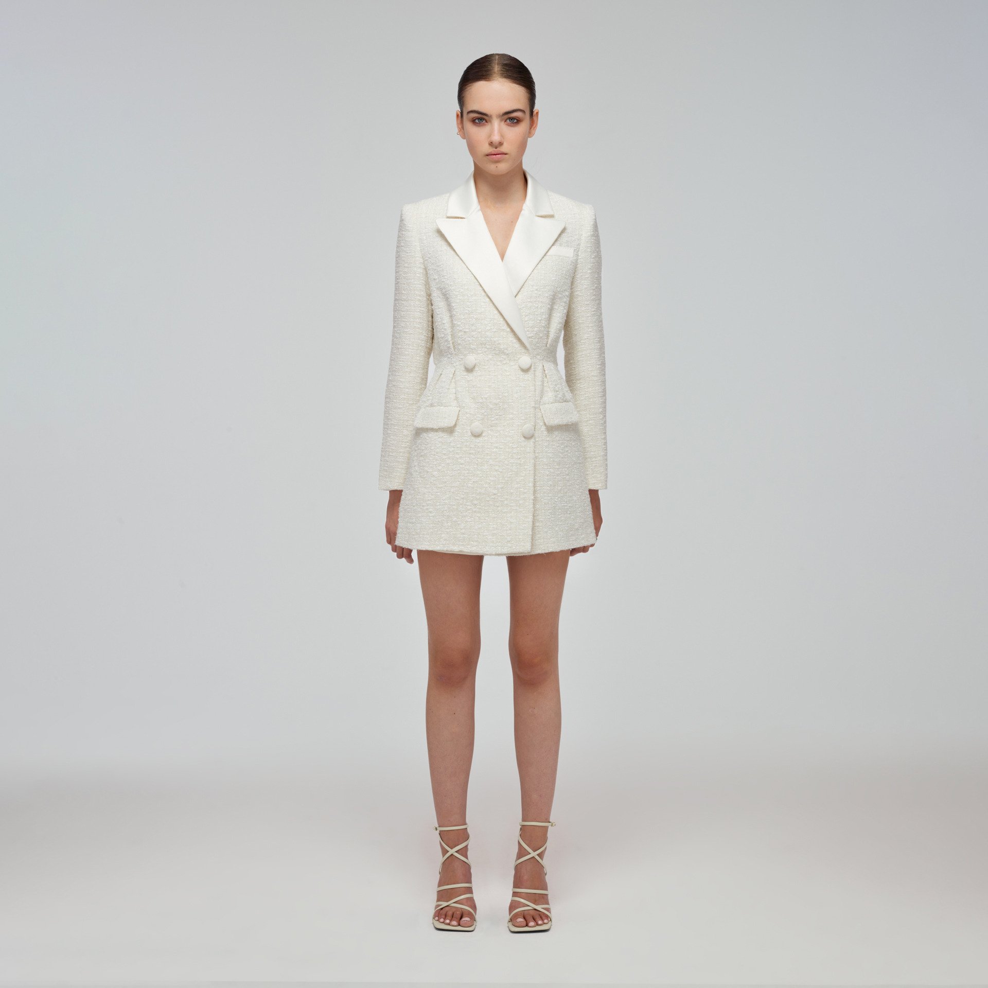 A blazer style white dress for a bridal shower from Self Portrait.