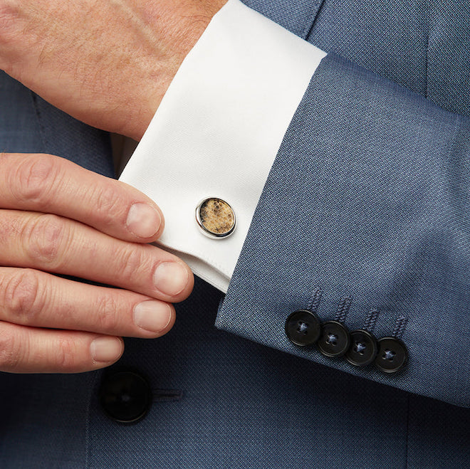 Model wearing the Galveston cufflink made of brown, black and ivory colored snakeskin by Brackish