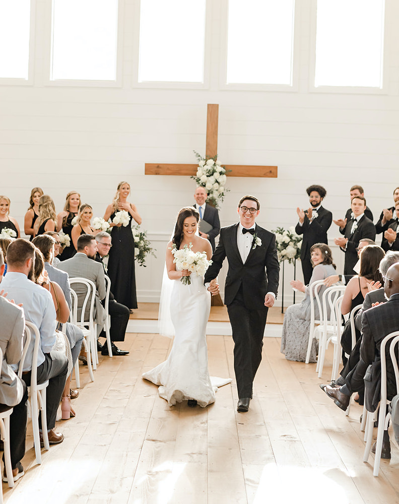 A bride and groom walk down the aisle as husband and wife at a chapel in Montgomery, TX.