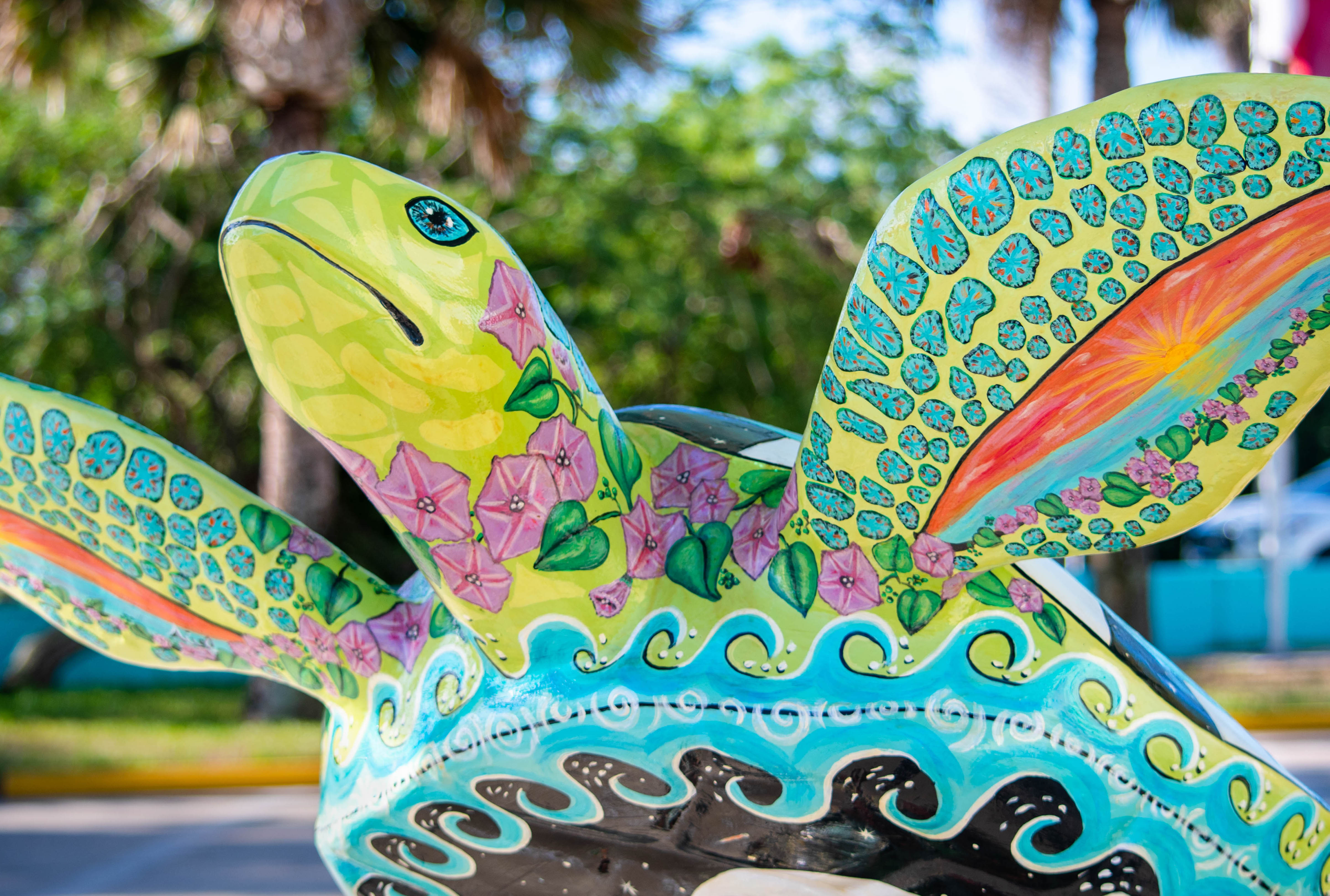 A sea turtle sculpture is hand-painted by an artist and it is on South Padre Island, TX.