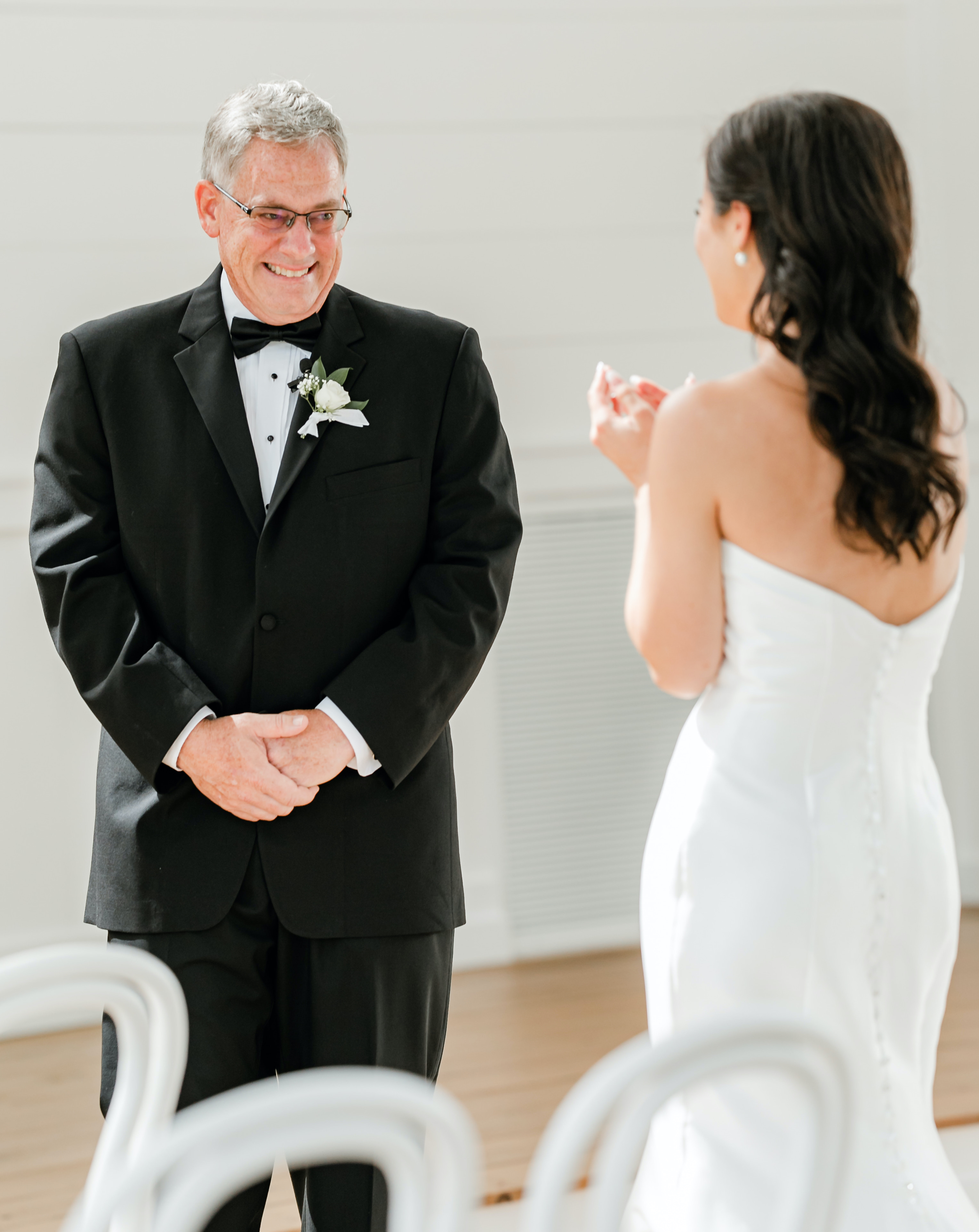 A bride does her first look with her father in a sunlit chapel in Montgomery, Texas.
