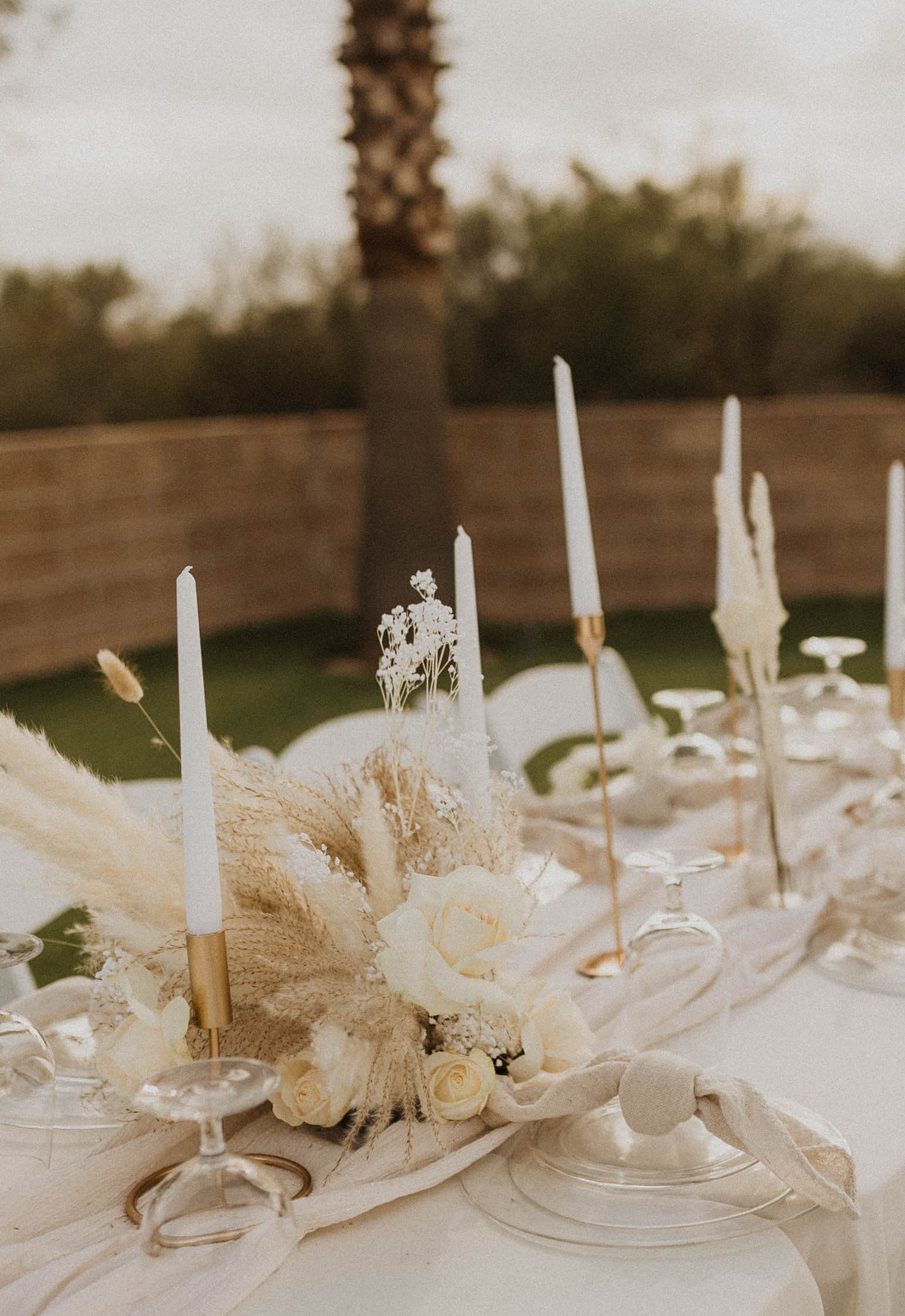 A outdoor wedding reception tablescape with ivory details in Arizona.