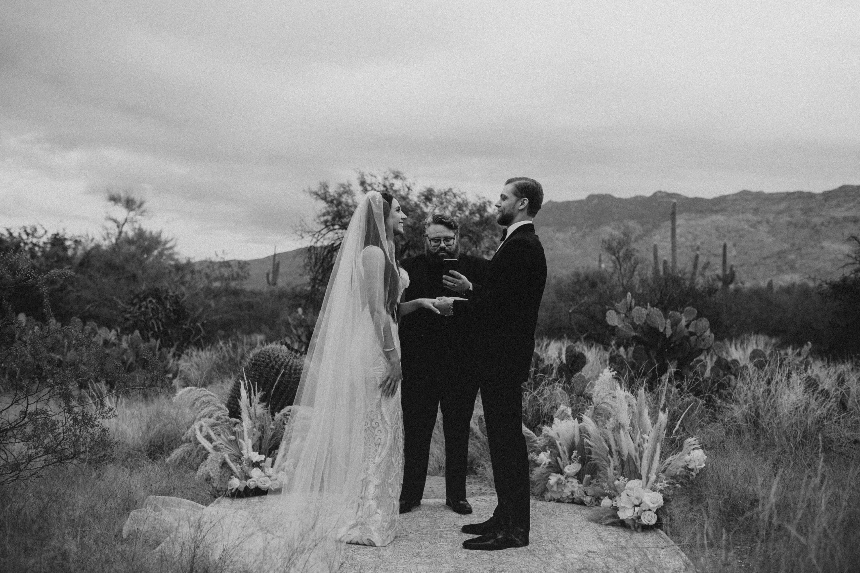A bride and groom stand at a makeshift altar in Arizona.