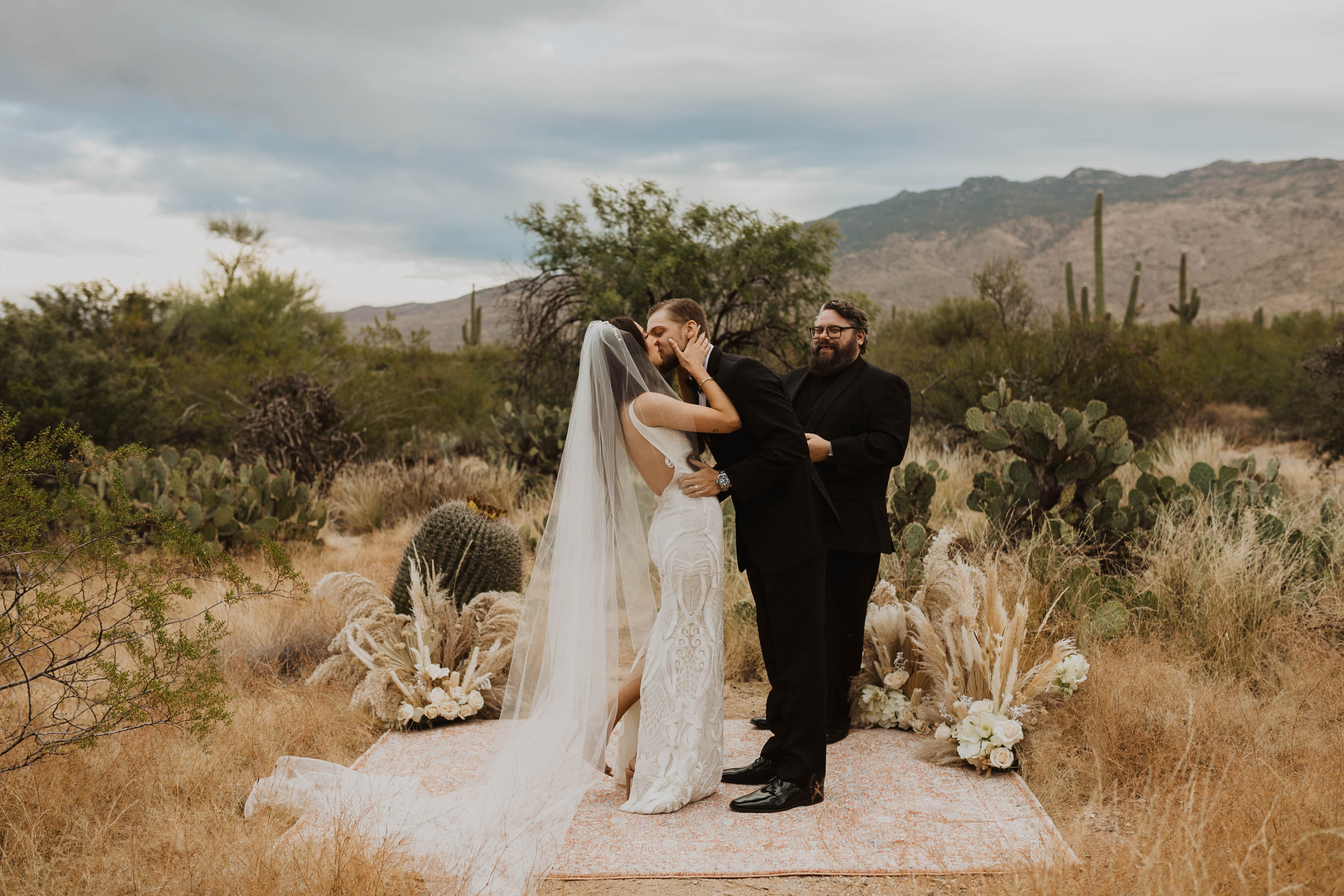 The groom kisses the bride at their desert elopement in Arizona.