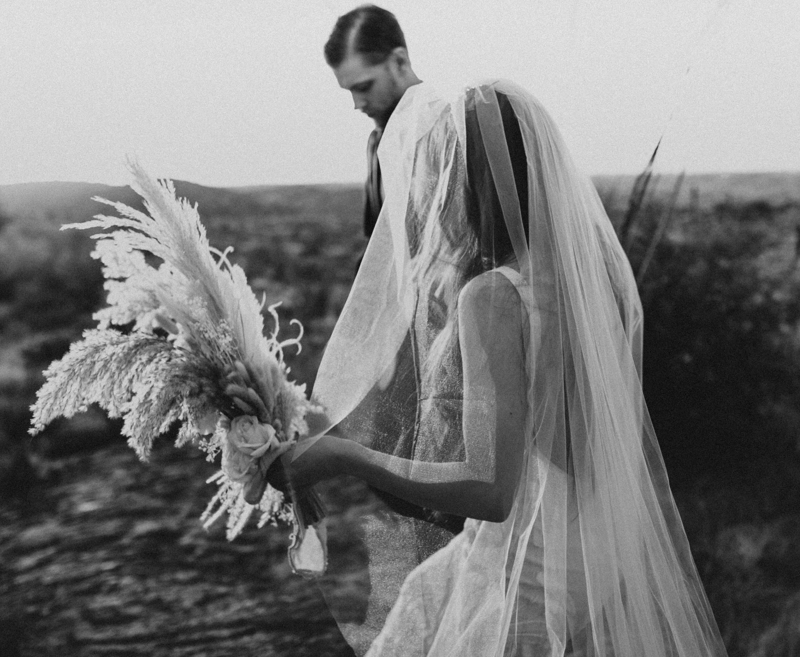 A bride and groom walk together outside in Arizona.