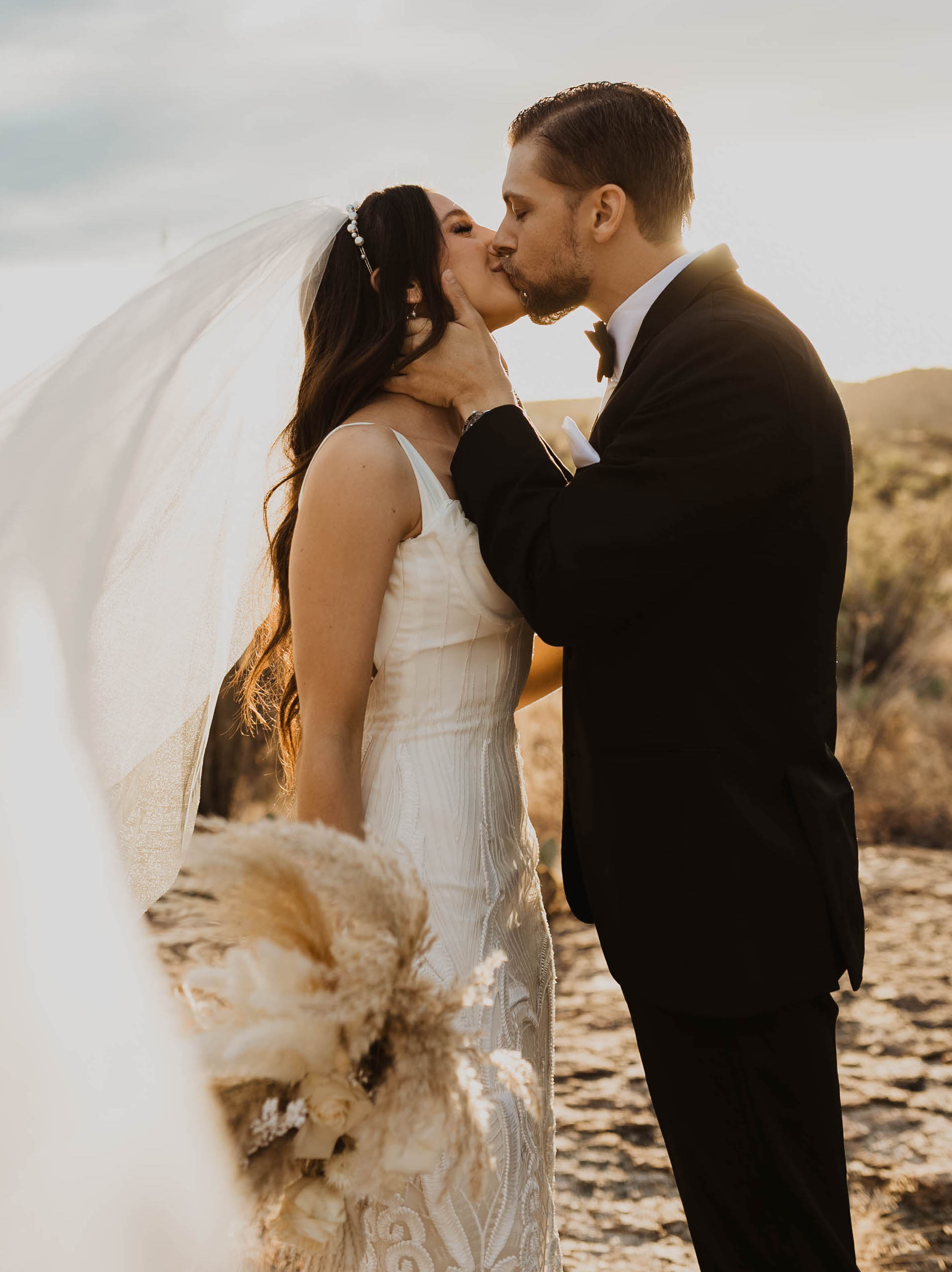 Riley from Caked Up With Riley kisses her groom at their elopement in Arizona.