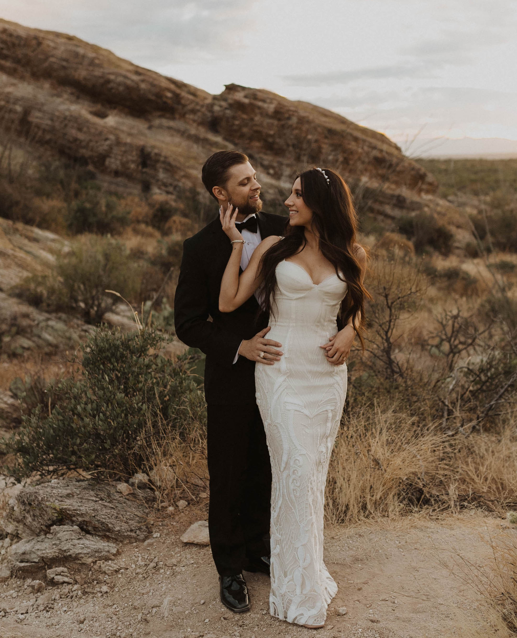 Bride wears a fitted gown with boho lace embellishments. Arizona wedding, elopement 