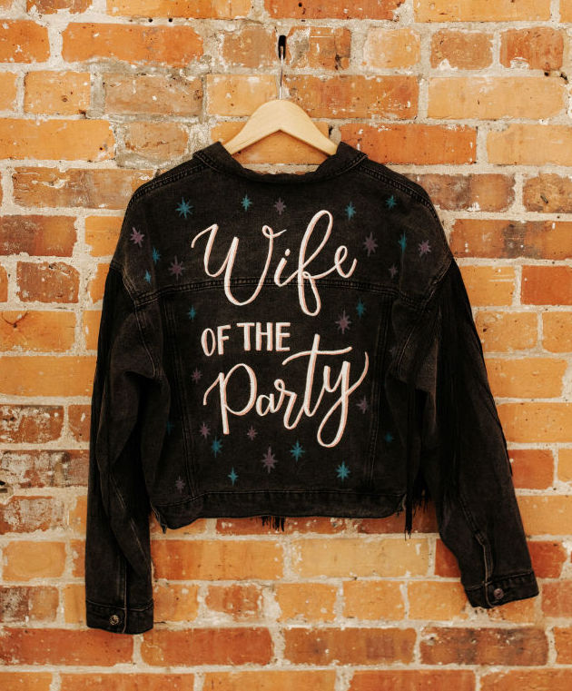 A black jean jacket for brides that says "Wife of the Party"