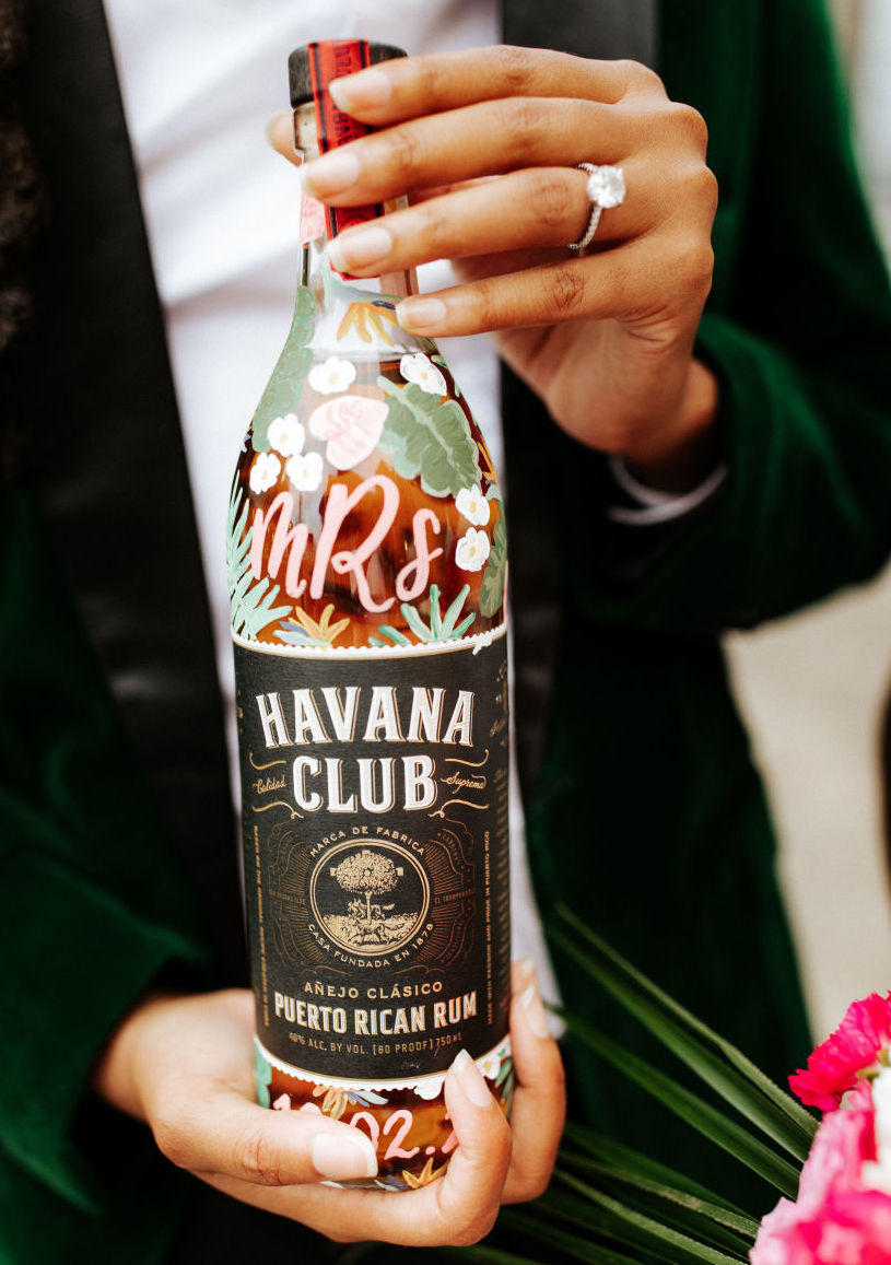 A hand-painted bottle with white flowers and palms. Havana Club Puerto Rican Rim. Custom hand-painted liquor bottle for weddings