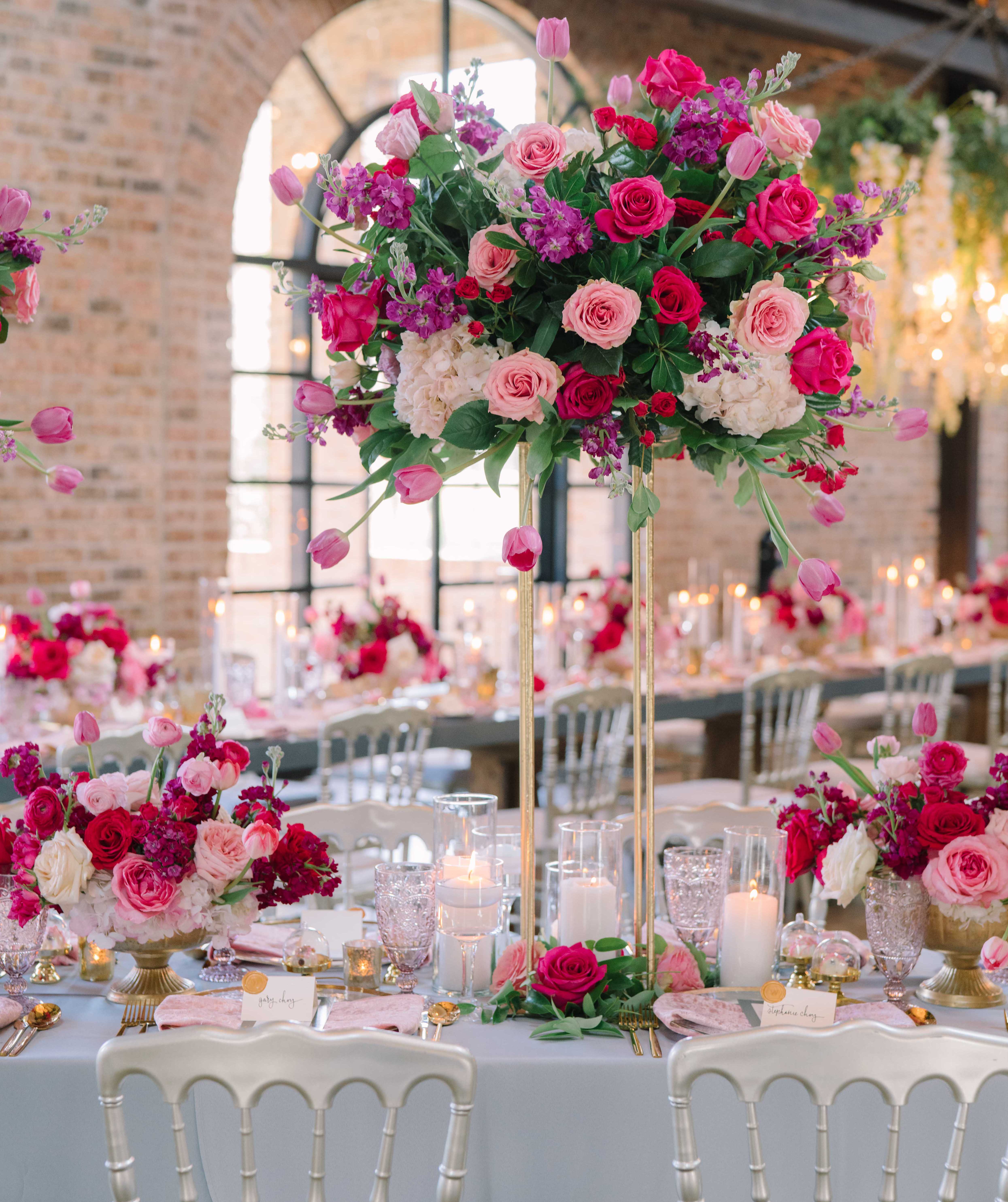 A bright pink wedding ceremony with pink flowers including roses, peonies, tulips and ranunculus. Summer Wedding With a Vibrant Palette of Pink
