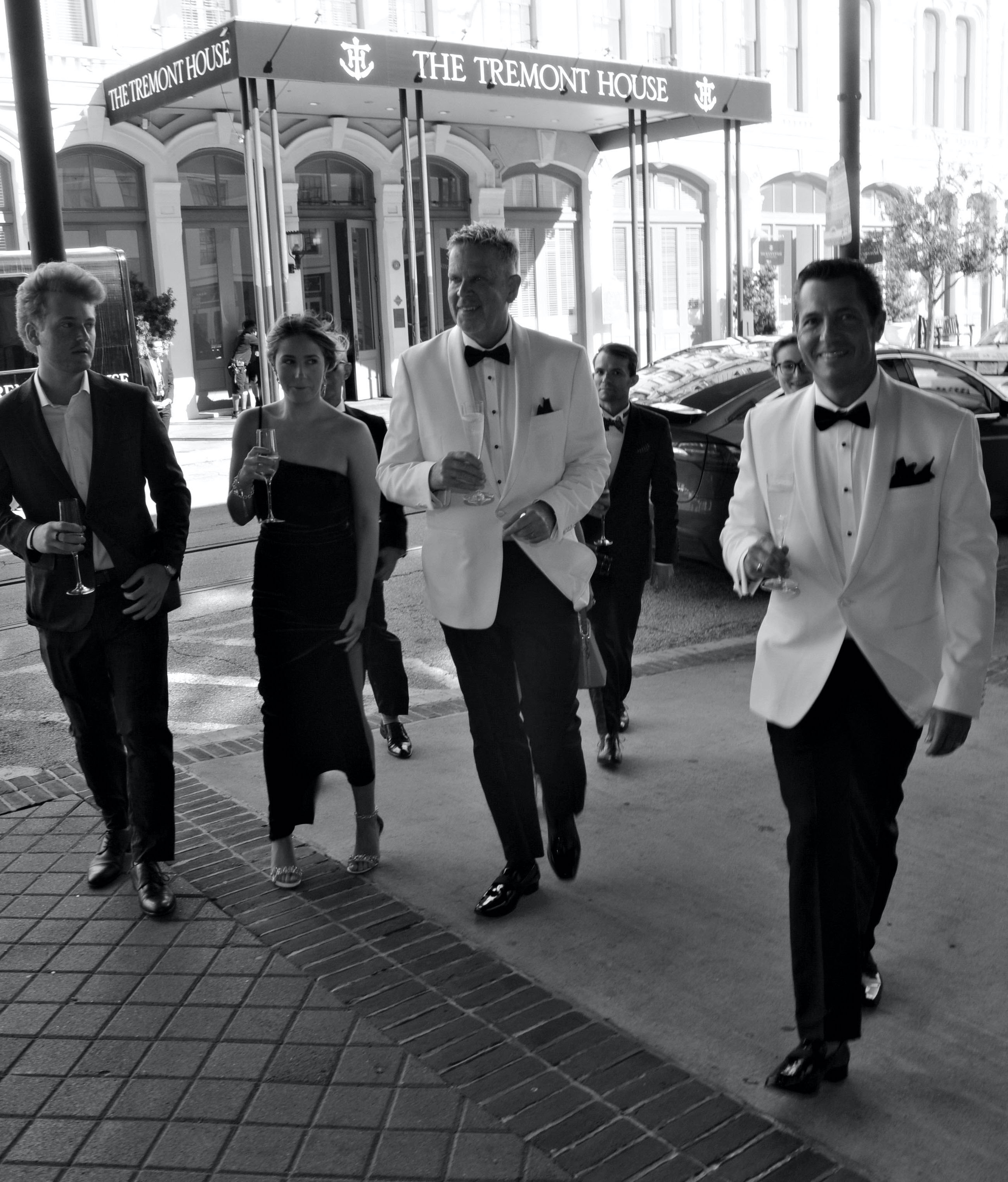 A LGBT couple walks with their wedding guests before their classic ceremony at The Tremont House Hotel in Galveston, Island.