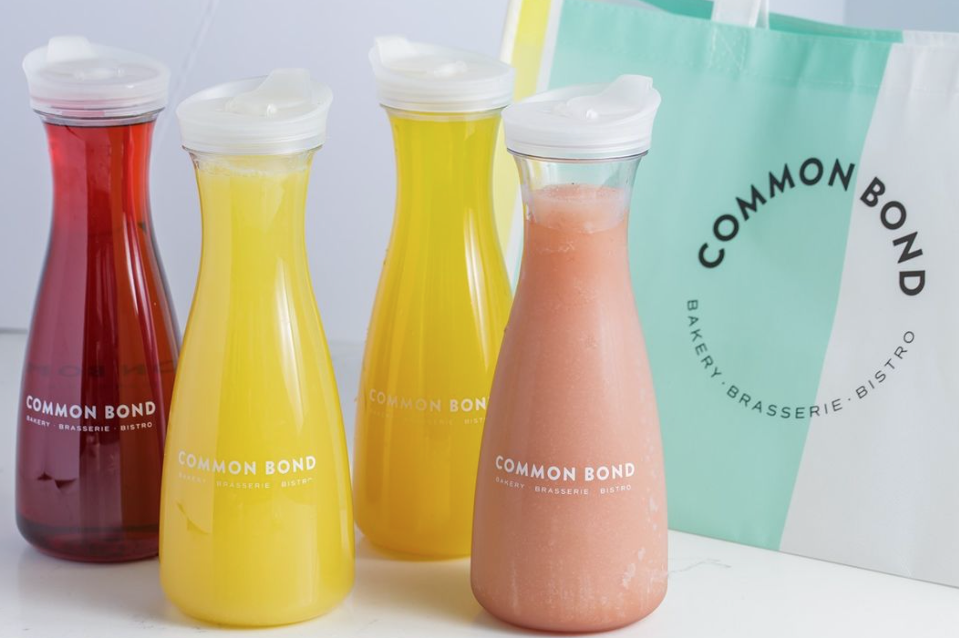 To-go carafes full of mimosas and frosé available at Common Bond Bistro & Bakery in Houston, TX.