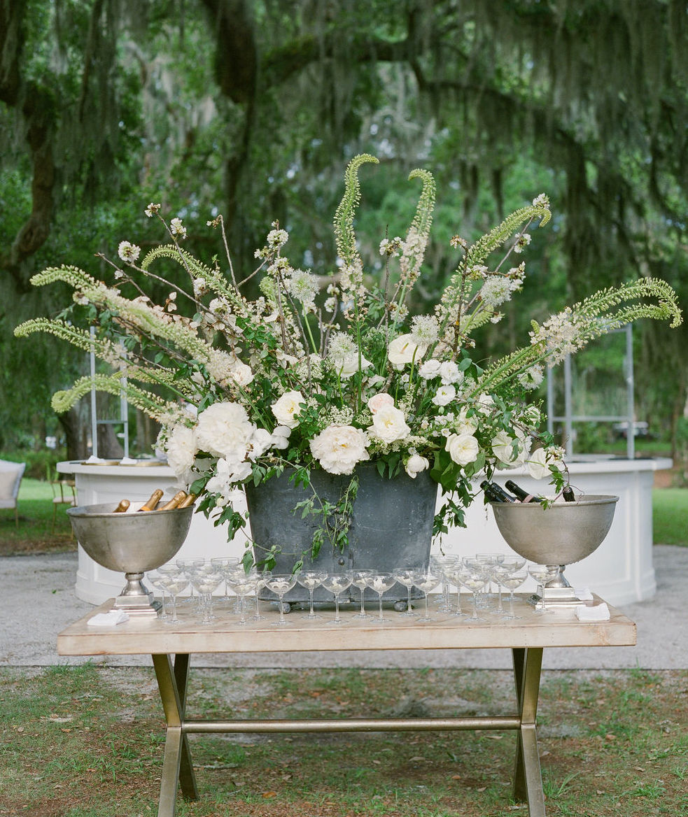 A champagne table at an alfresco wedding in the Lowcountry designed by Tara Géurard Soirée.