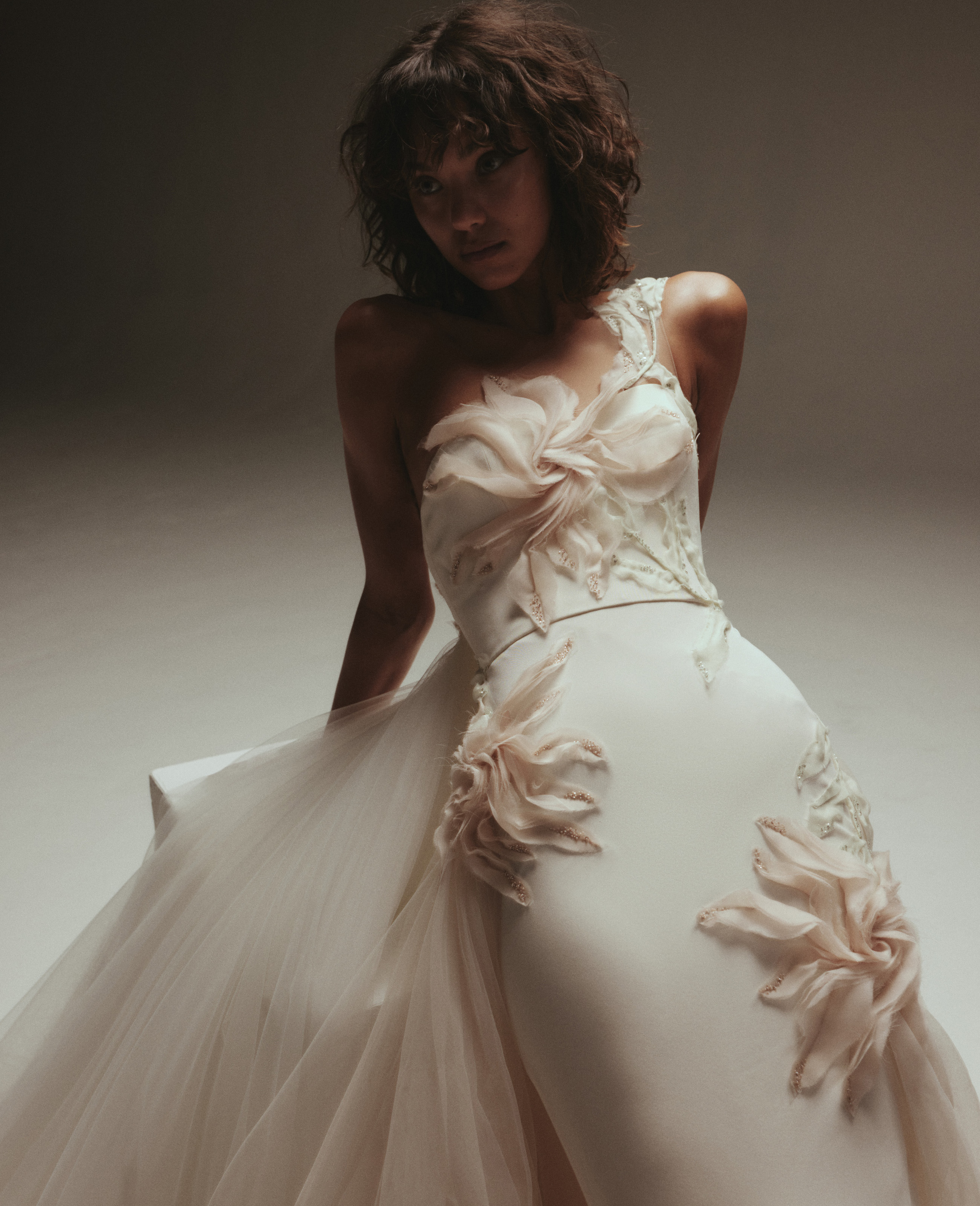 Single strap gown with blush stitched flowers and a tulle skirt.