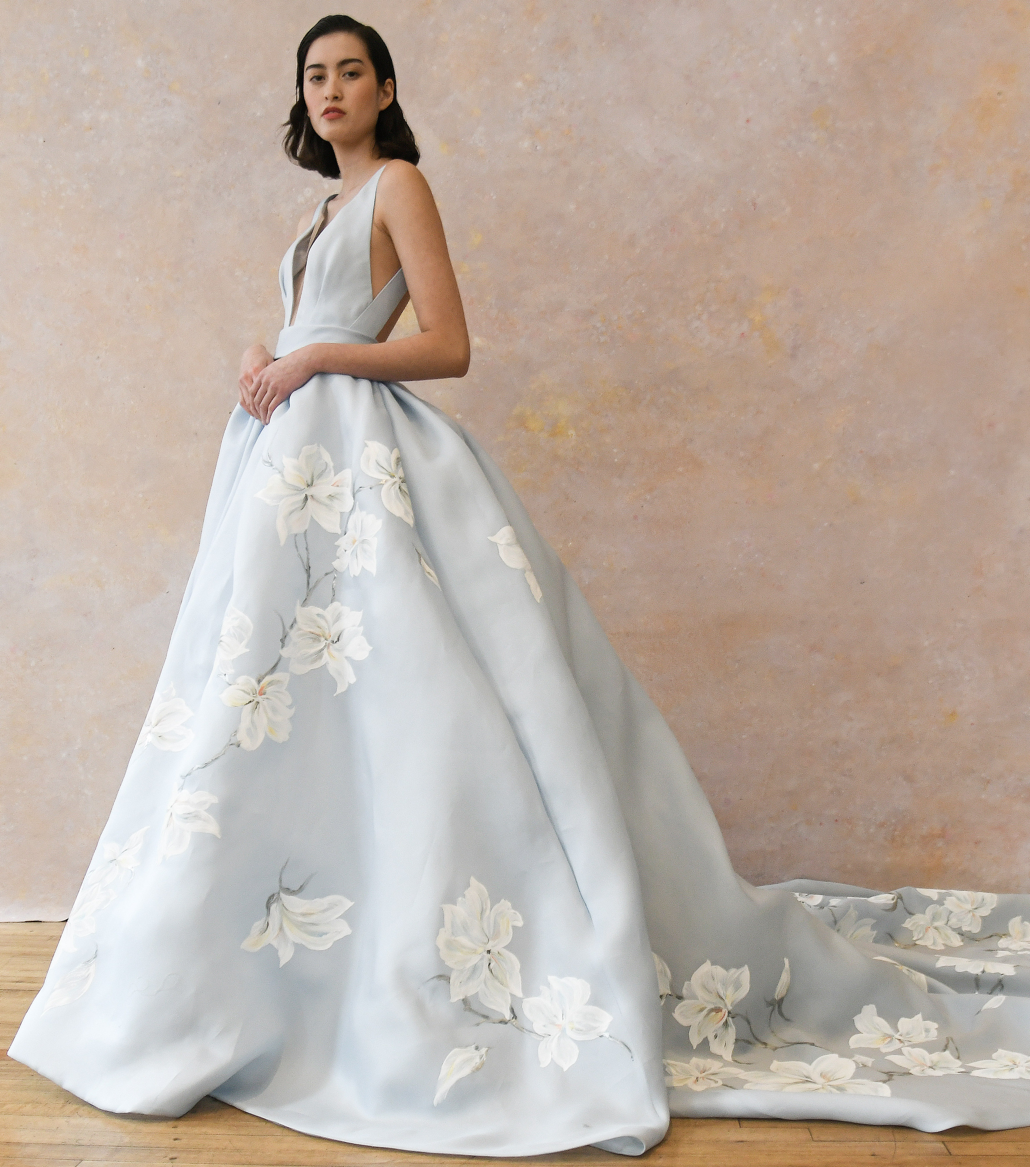  designed by Ines Di Santo. A baby blue wedding gown with white flowers trailing down the skirt.
