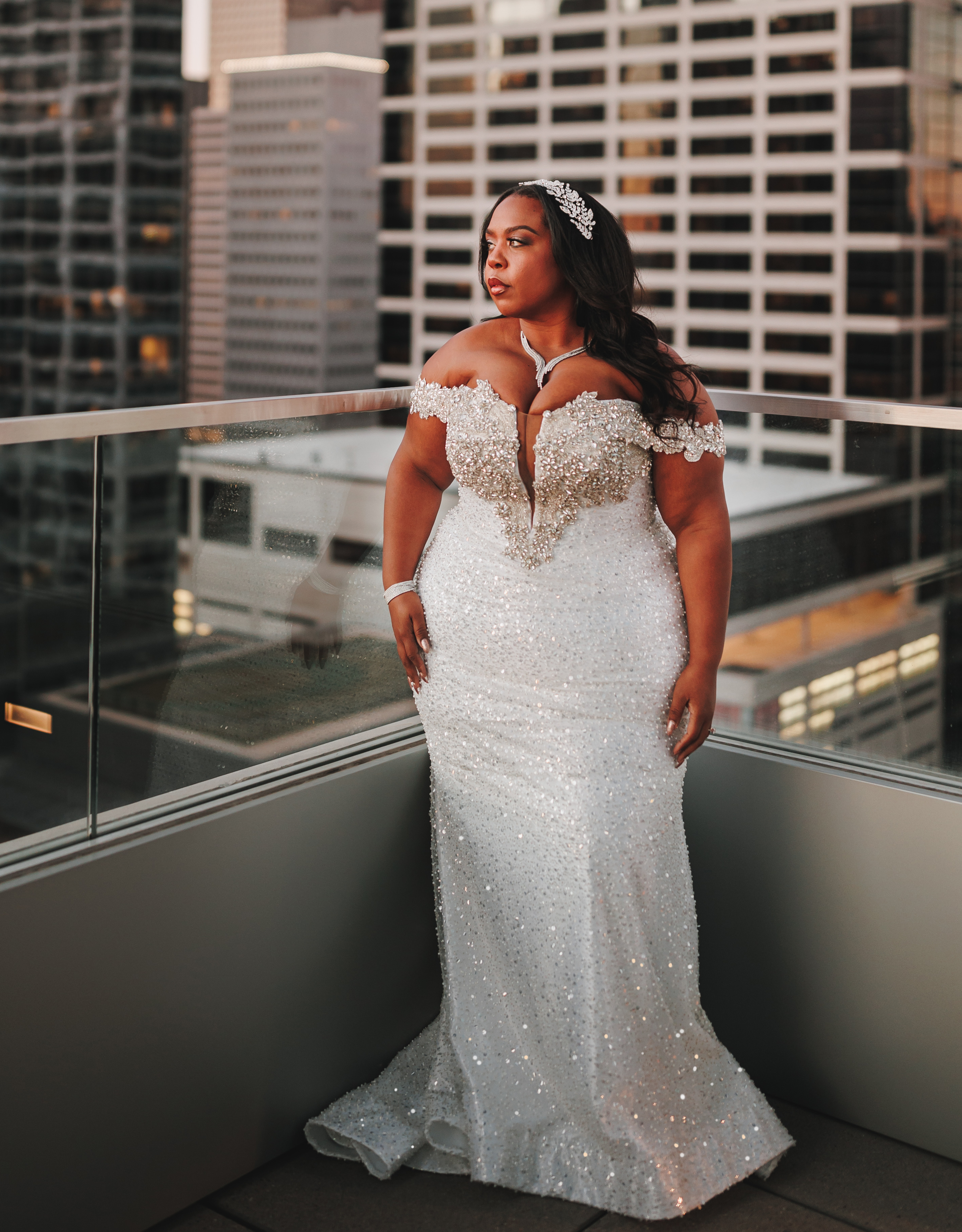 Bride, Ashley Turner, looks out into the horizon in her sparkling wedding gown during her Houston skyline bridal shoot.