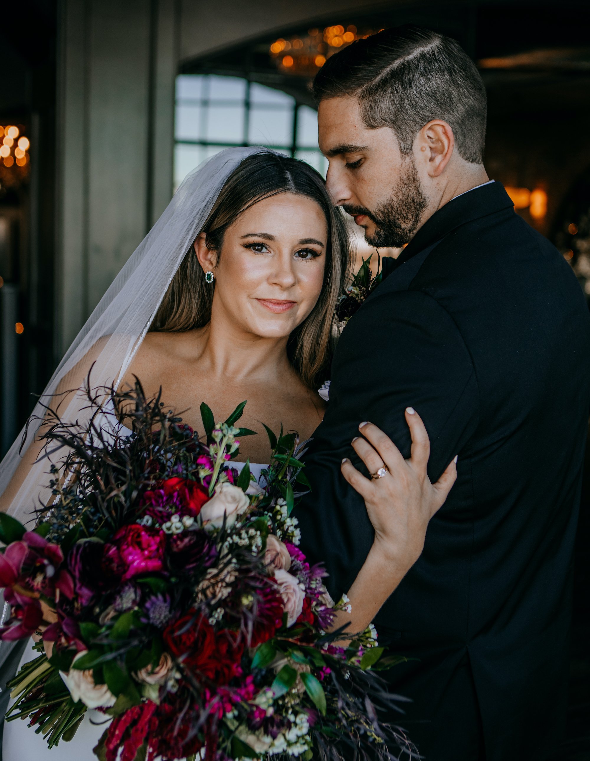 A bride and groom pose before their Jewel Toned Wedding With Art Deco Vibes in Houston, TX.