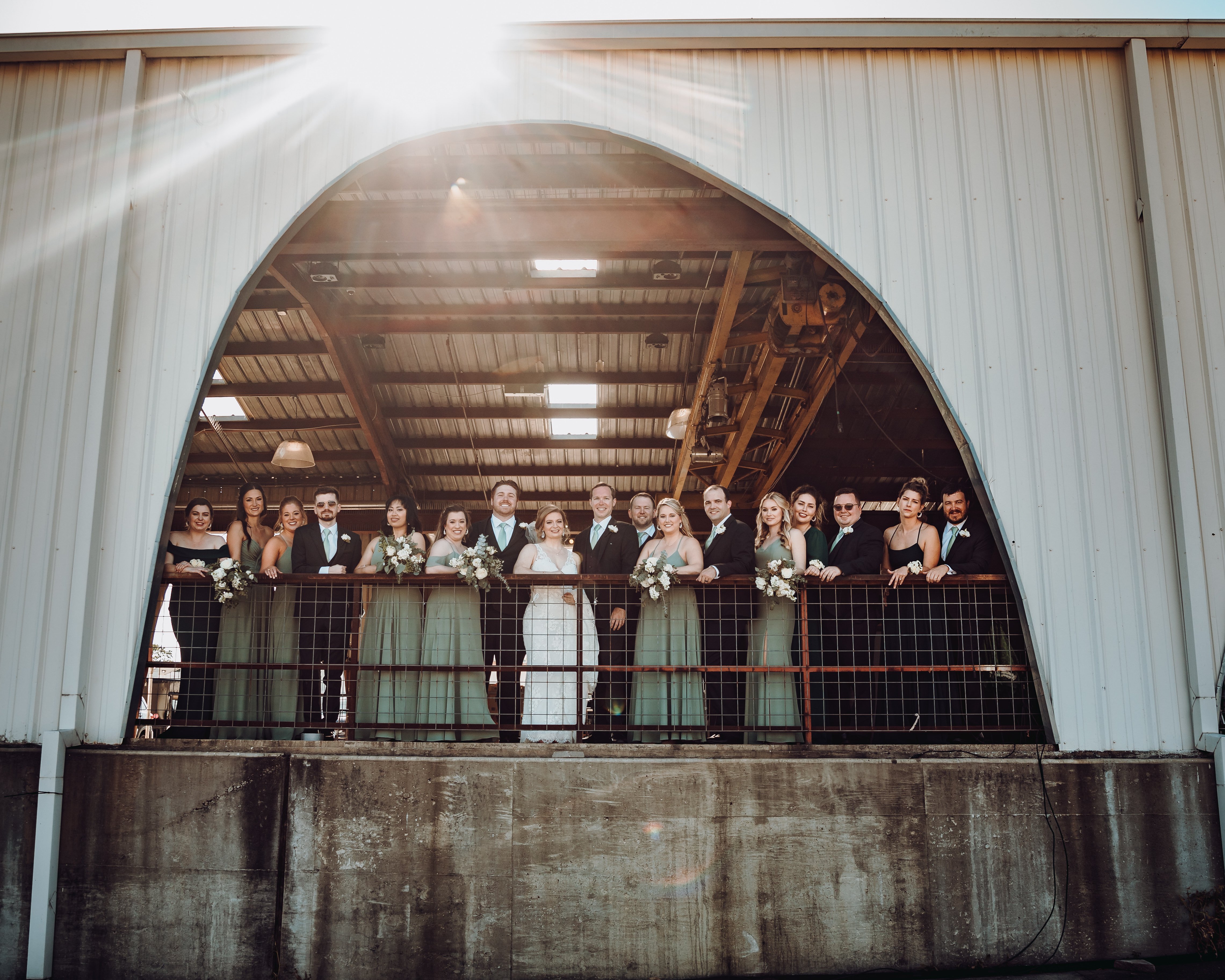 A bride and groom pose with their wedding party after their wedding ceremony in Houston, TX.