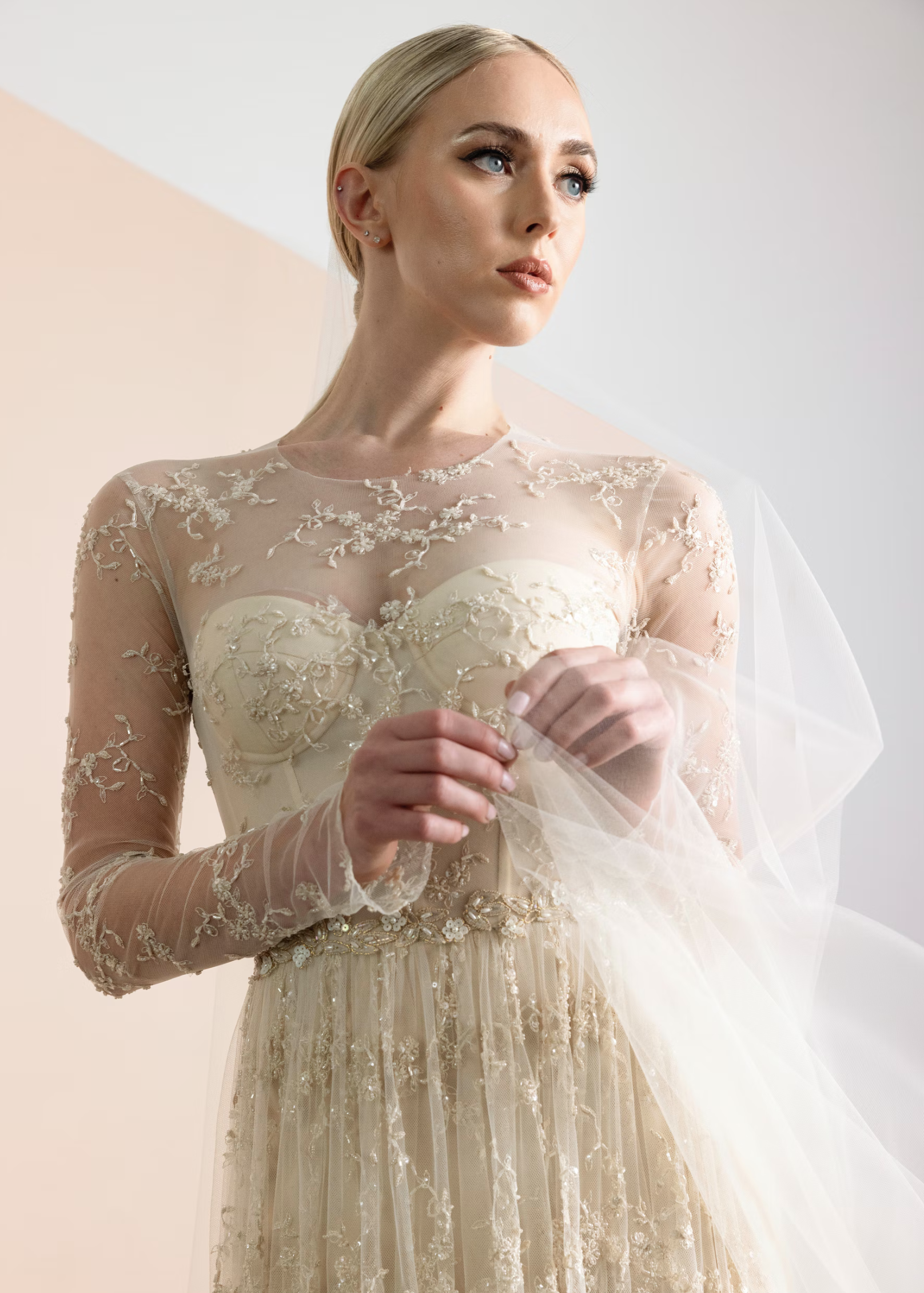 Romona Keveza gold wedding gown with sheer sleeves.