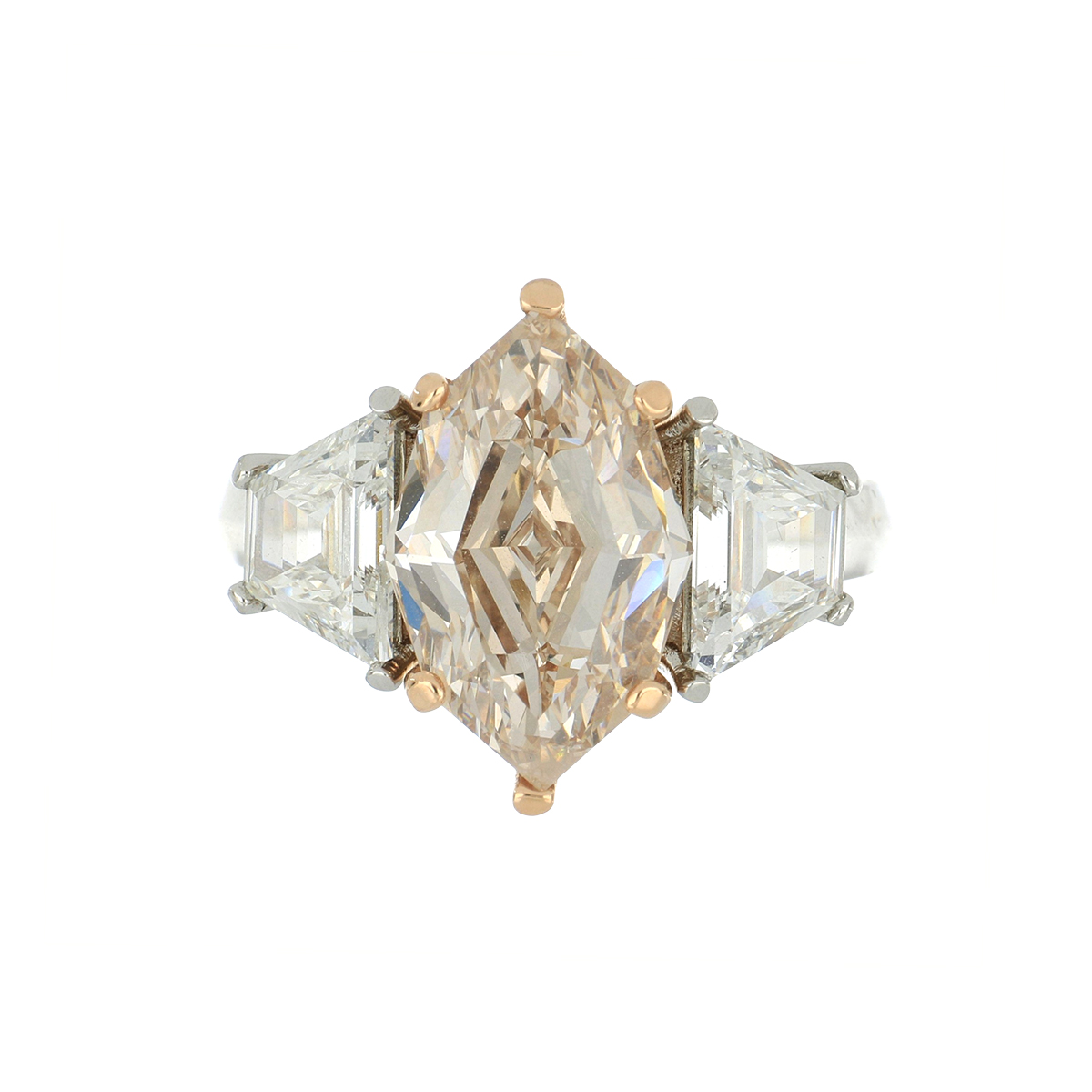 An estate three-stone engagement ring with a rose gold diamond from Tenenbaum Jewelers in Houston, TX.