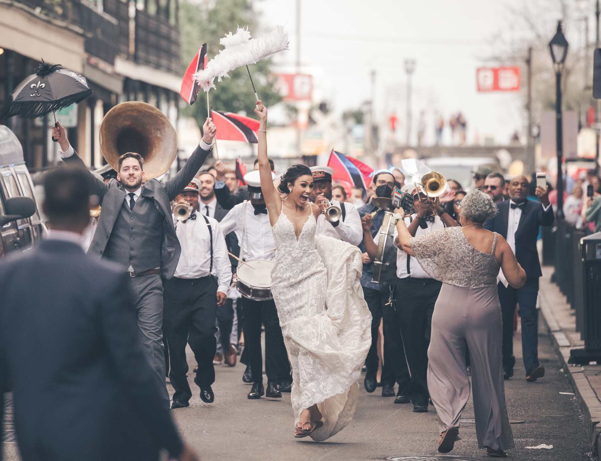 A bride and groom parade the streets of NOLA during their wedding day. French Quarter wedding.