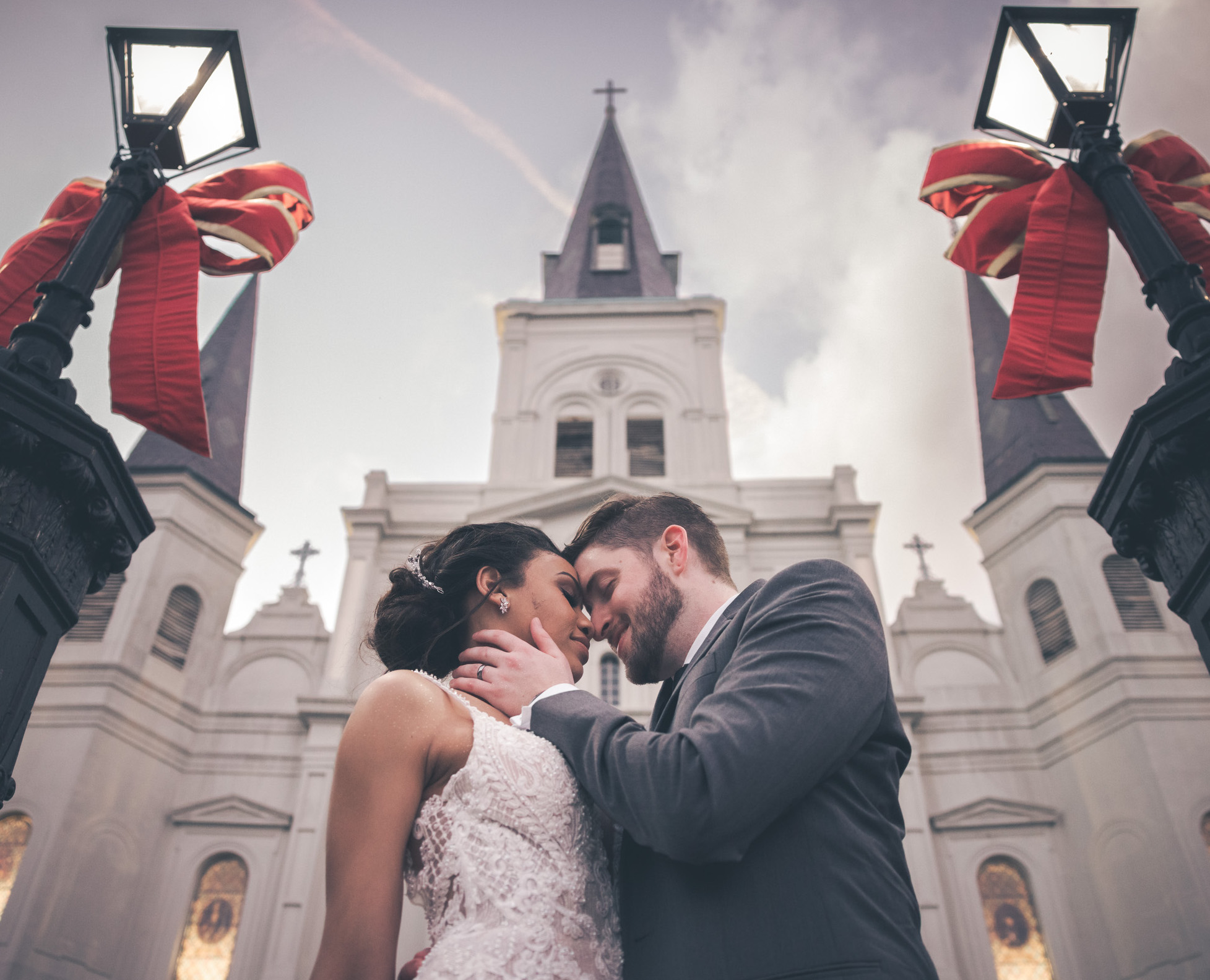 A bride and groom embrace each other while standing in the French Quarter in New Orleans on their wedding day.