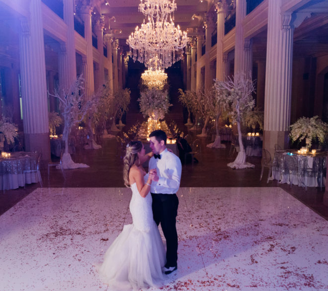 Bride and groom dance in an empty reception hall at The Corinthian Houston. 