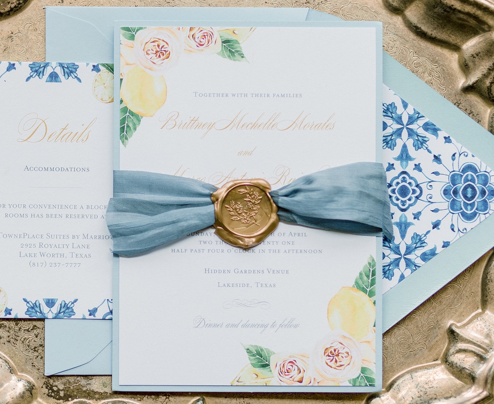 A wedding invitation suite with light blue hues and pink flowers and lemons created by Houston stationery professional, Wild Wolf Creative Co.