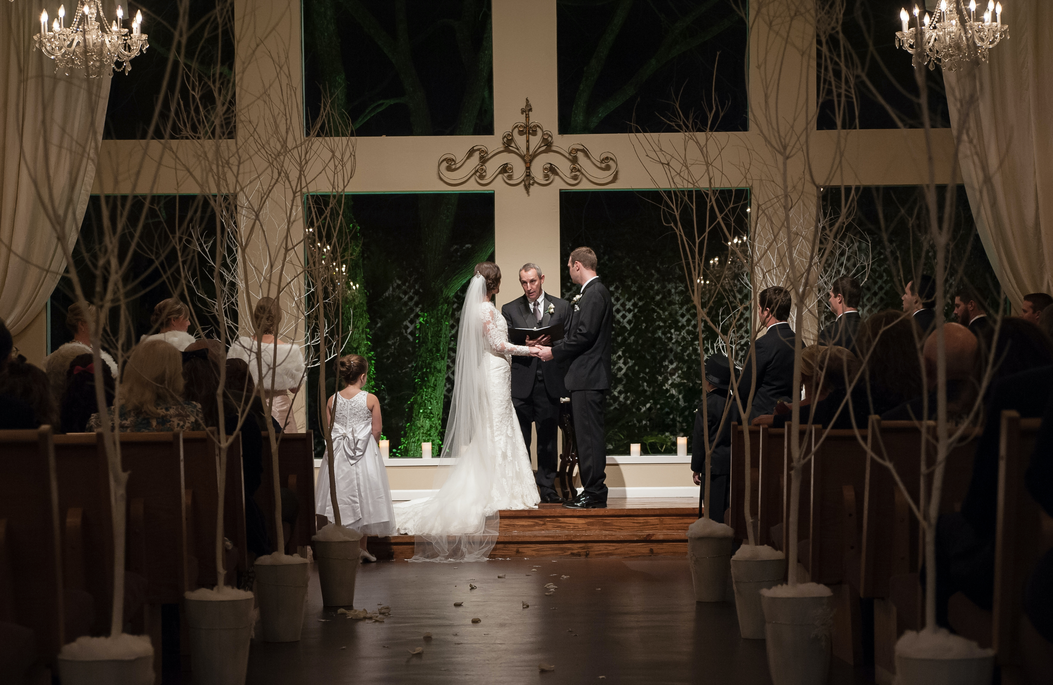 A bride and groom stand at the altar during their wedding at Heather’s Glen.