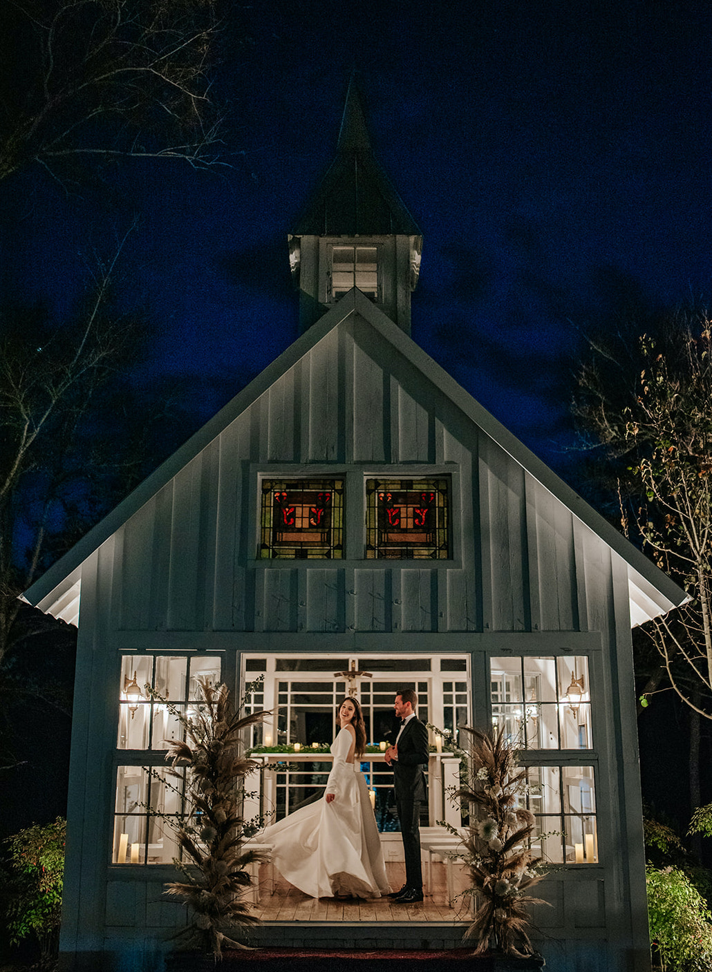 A bride and groom dance inside a small lit chapel at 7F Lodge & Events in College, Station at night. 