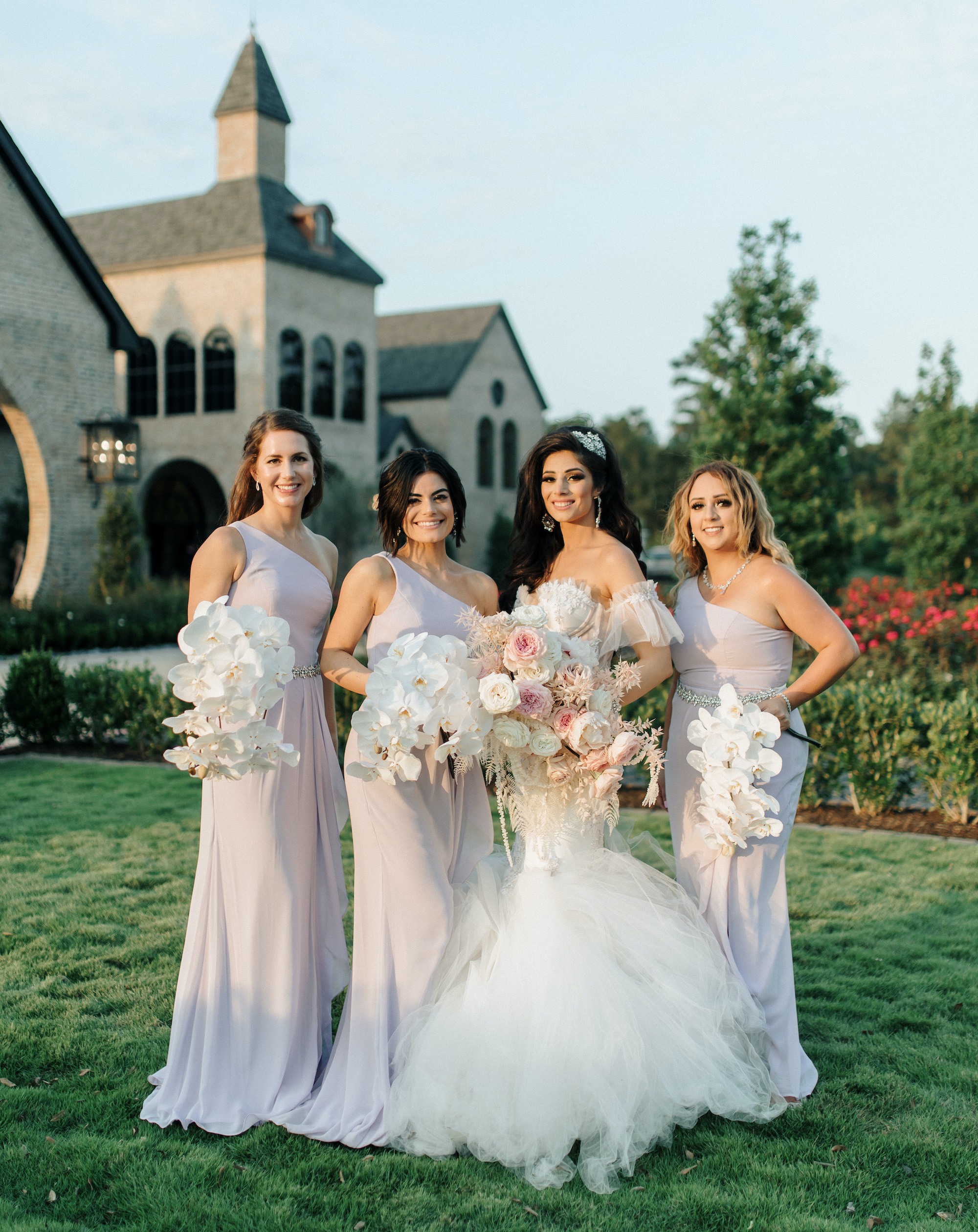 A bride stands with her three bridesmaids outside of her wedding venue in Montgomery, TX.
