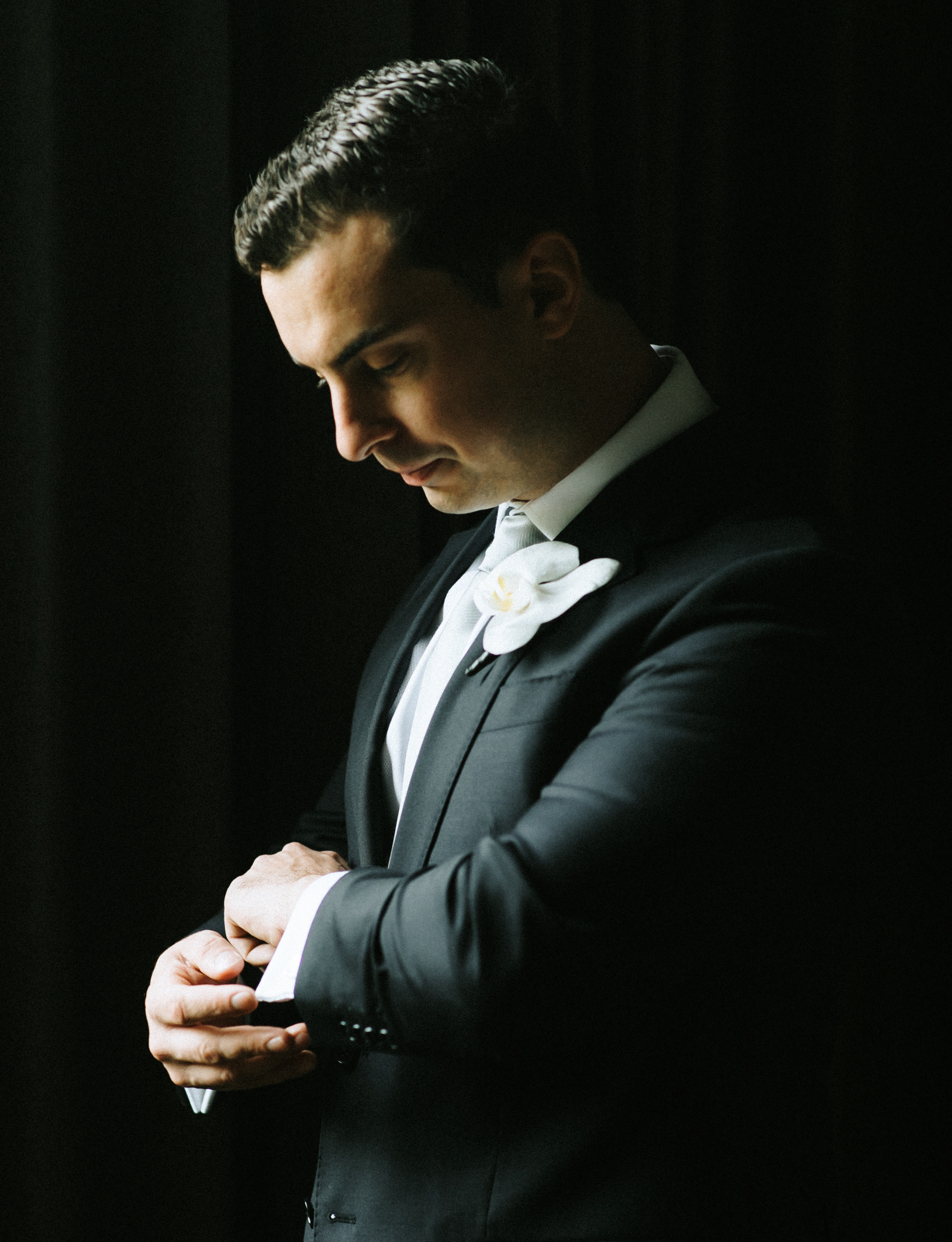 A groom gets ready for his pink and lilac Persian wedding in Montgomery, TX.