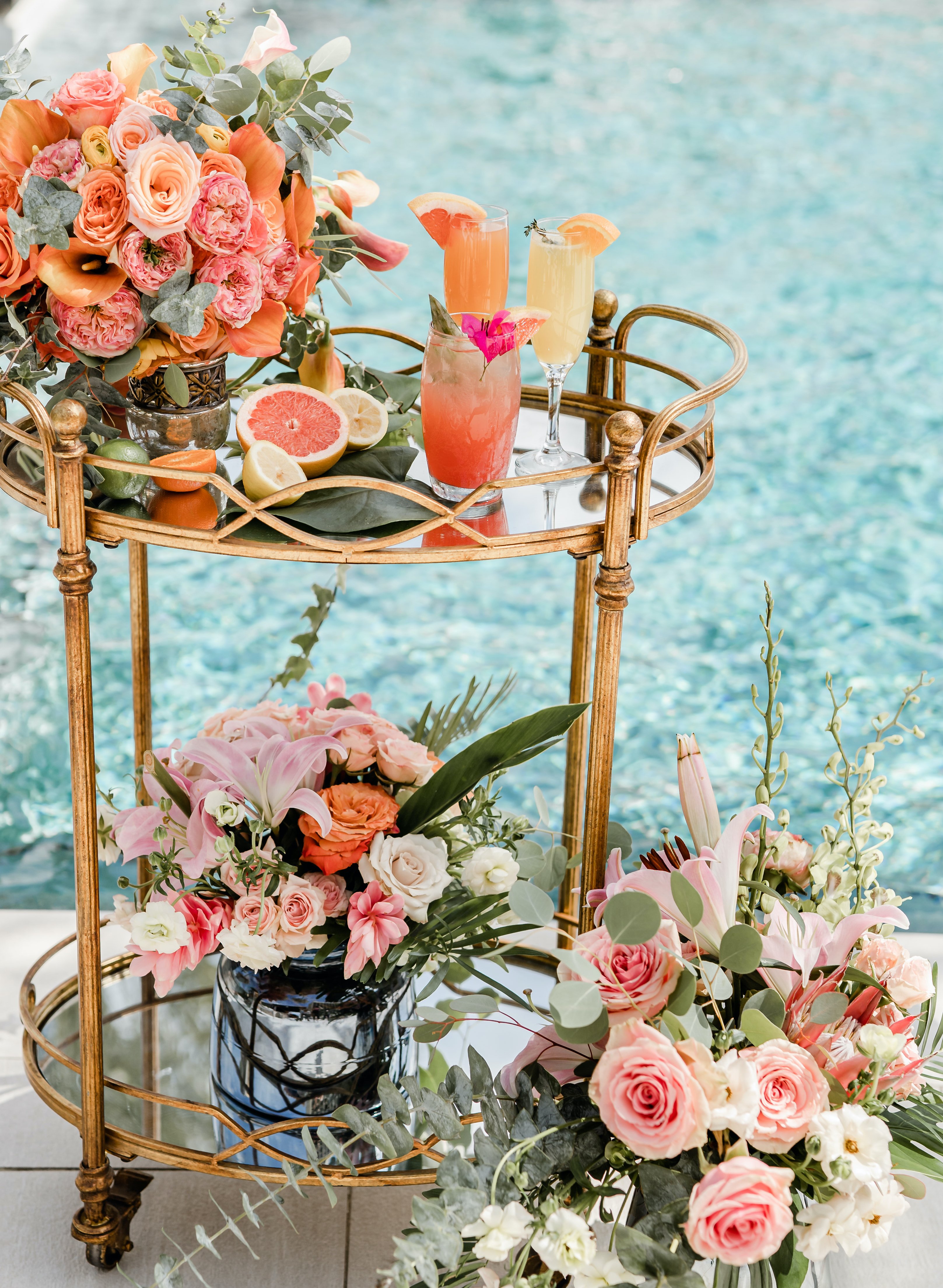A cocktail cart full of tropical flowers and fun cocktails is by the pool at The San Luis Resort, Spa & Conference Center.
