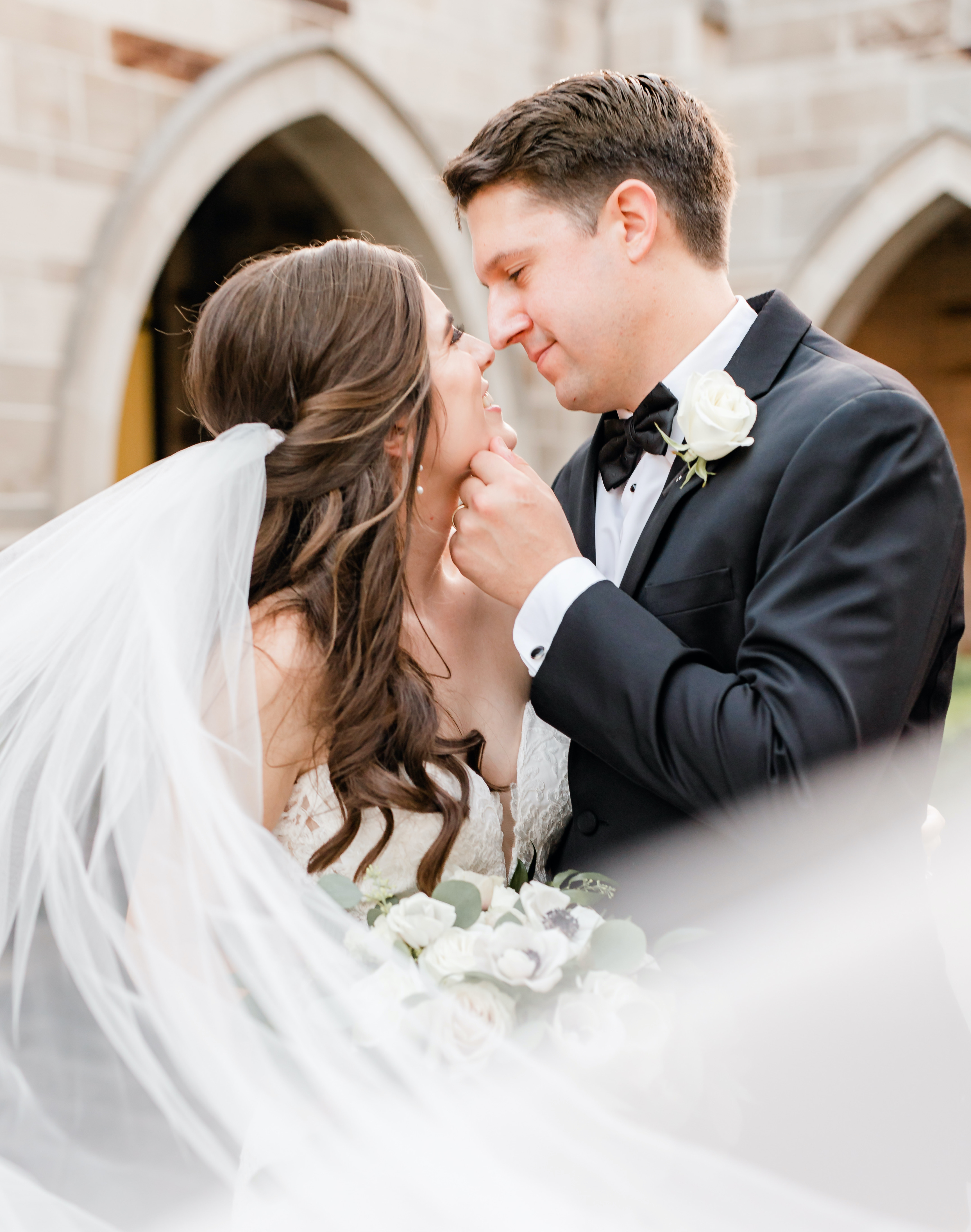 A bride and groom look at each other while outside of a church in Houston.
