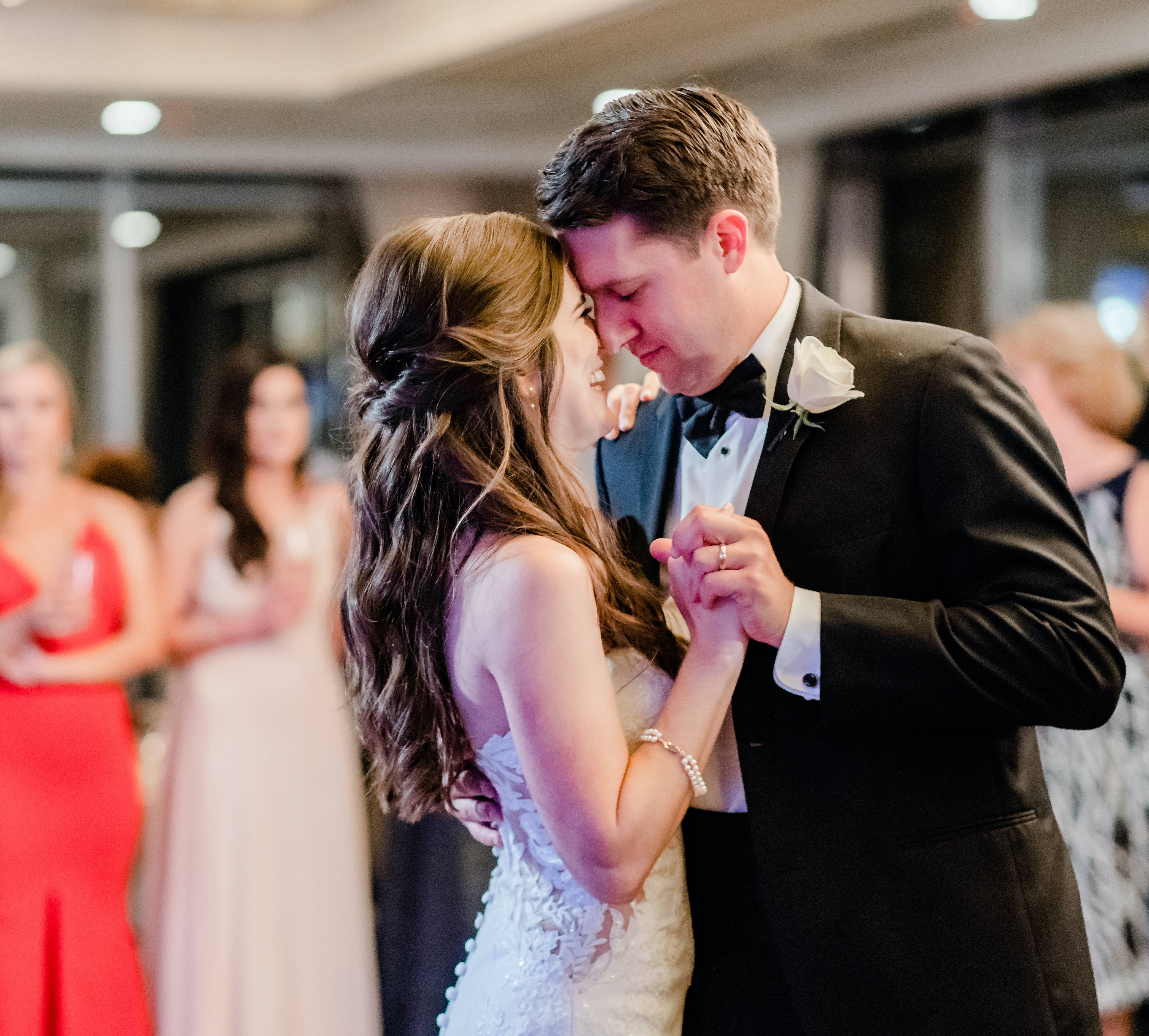 A bride and groom dance at their reception in front of their guests at The Petroleum Club of Houston.