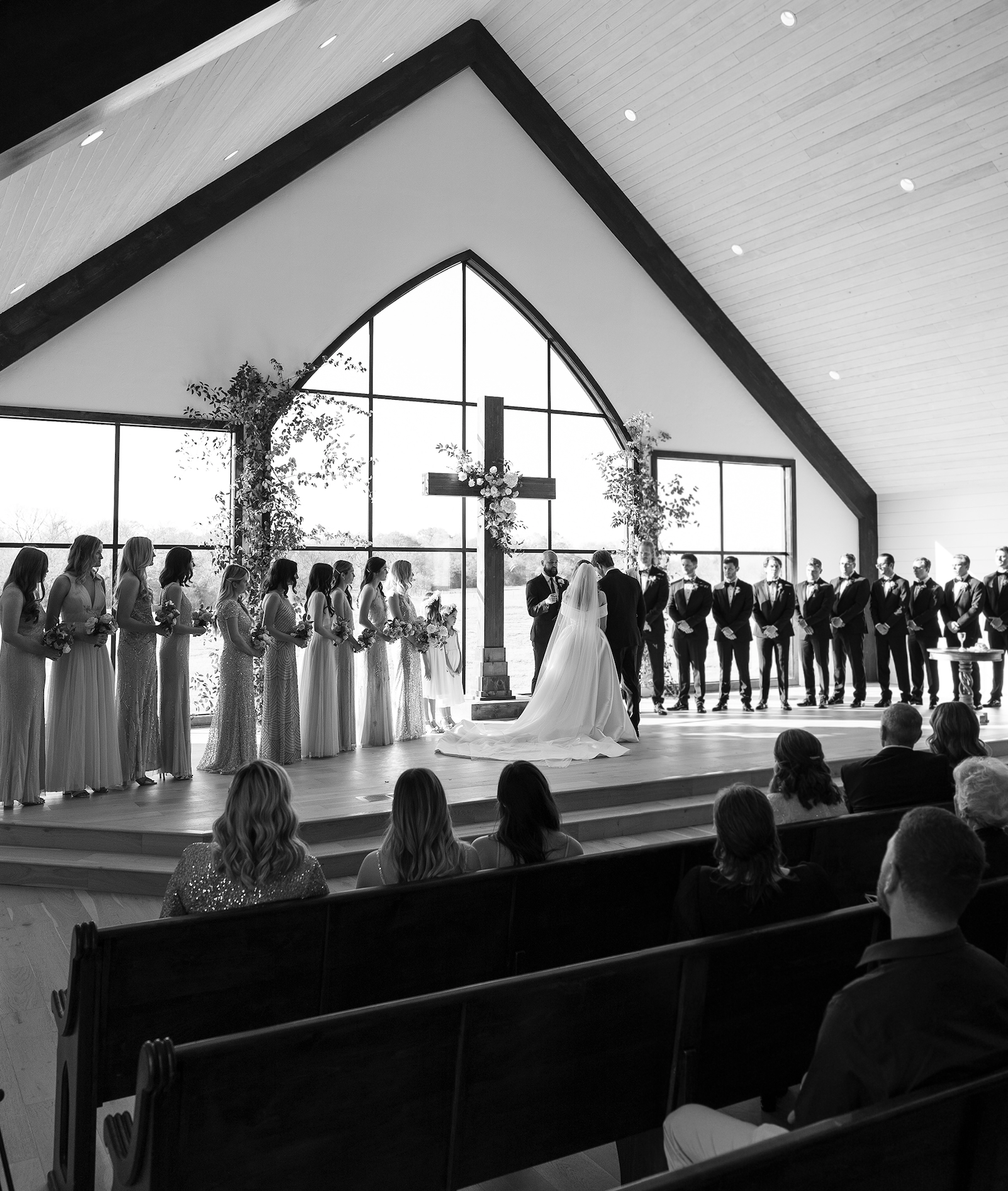 A black and white photo of a bride and groom getting married at Deep in the Heart Farms, a venue in Brenham, TX. Texas Wedding Venues With On-Site Chapels