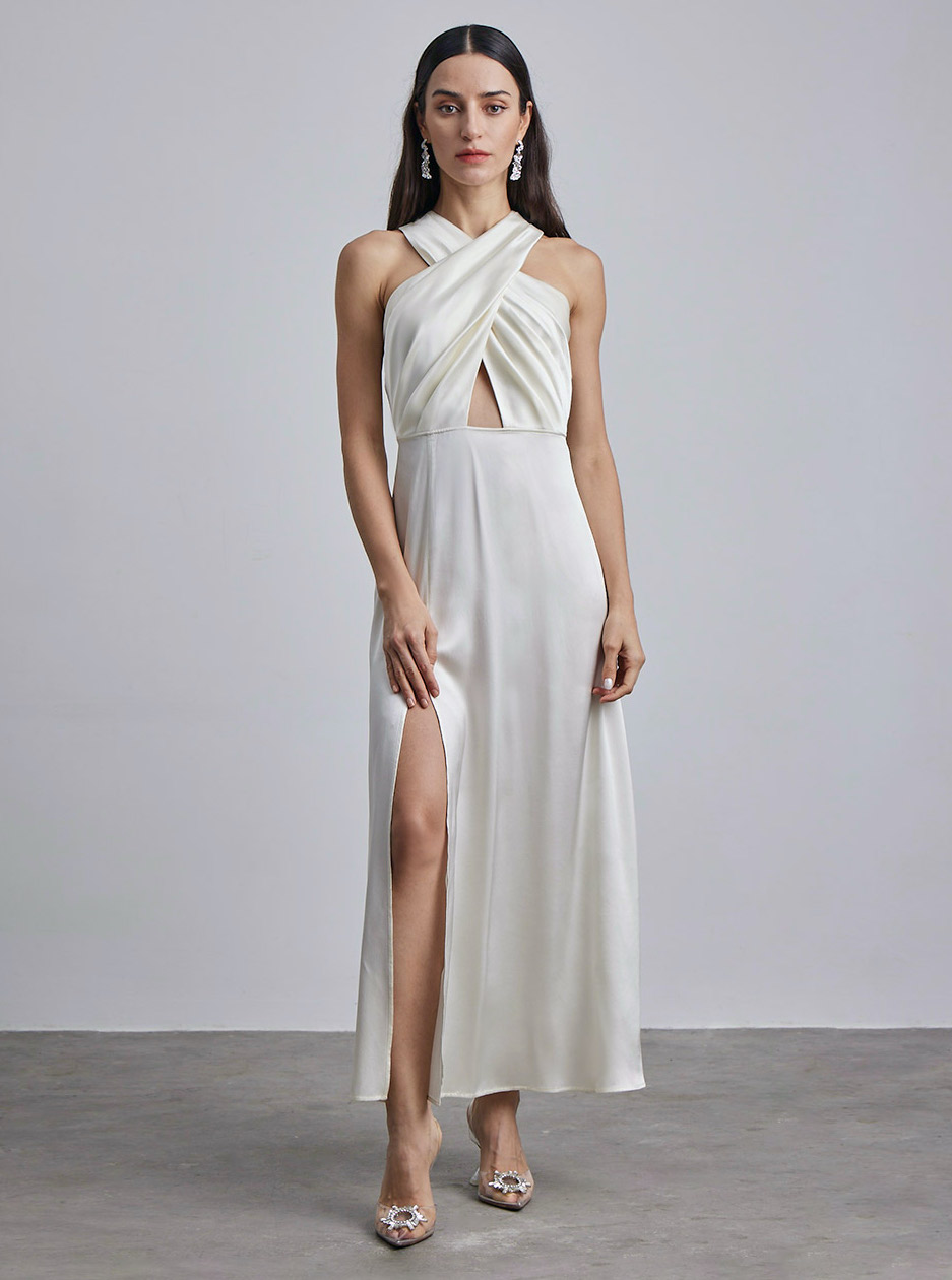 A white halter neck dress with a cutout in the center available at Silk Maison. Perfect for summer honeymoon must-haves.