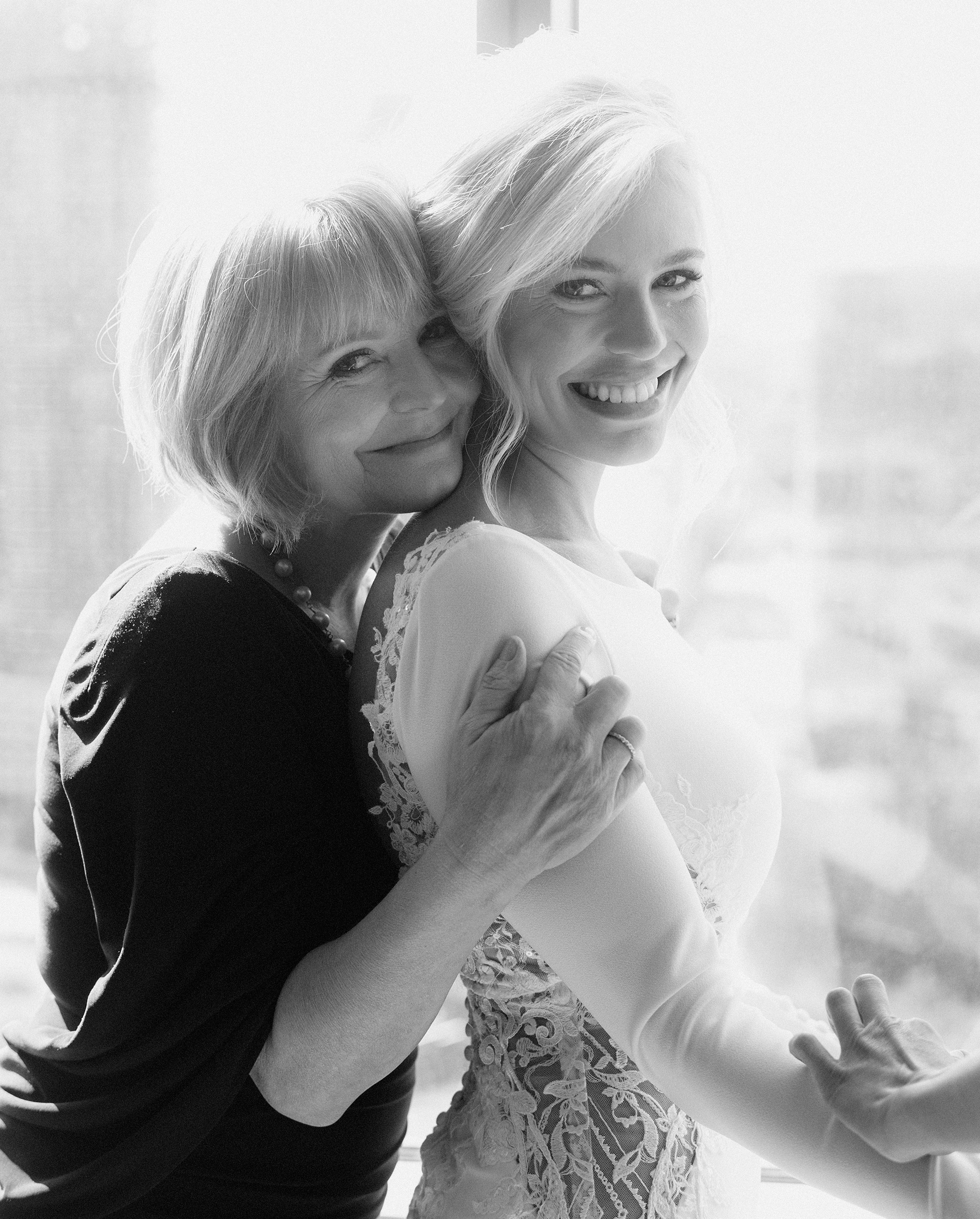 A black and white photo of a bride and her mother before her romantic ballroom wedding in Houston.