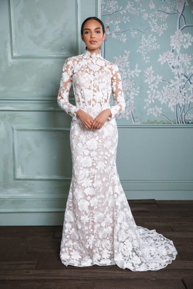 Woman in a high neck, fitted lace wedding dress from 2023 bridal collection by Anne Barge. English Garden Inspired