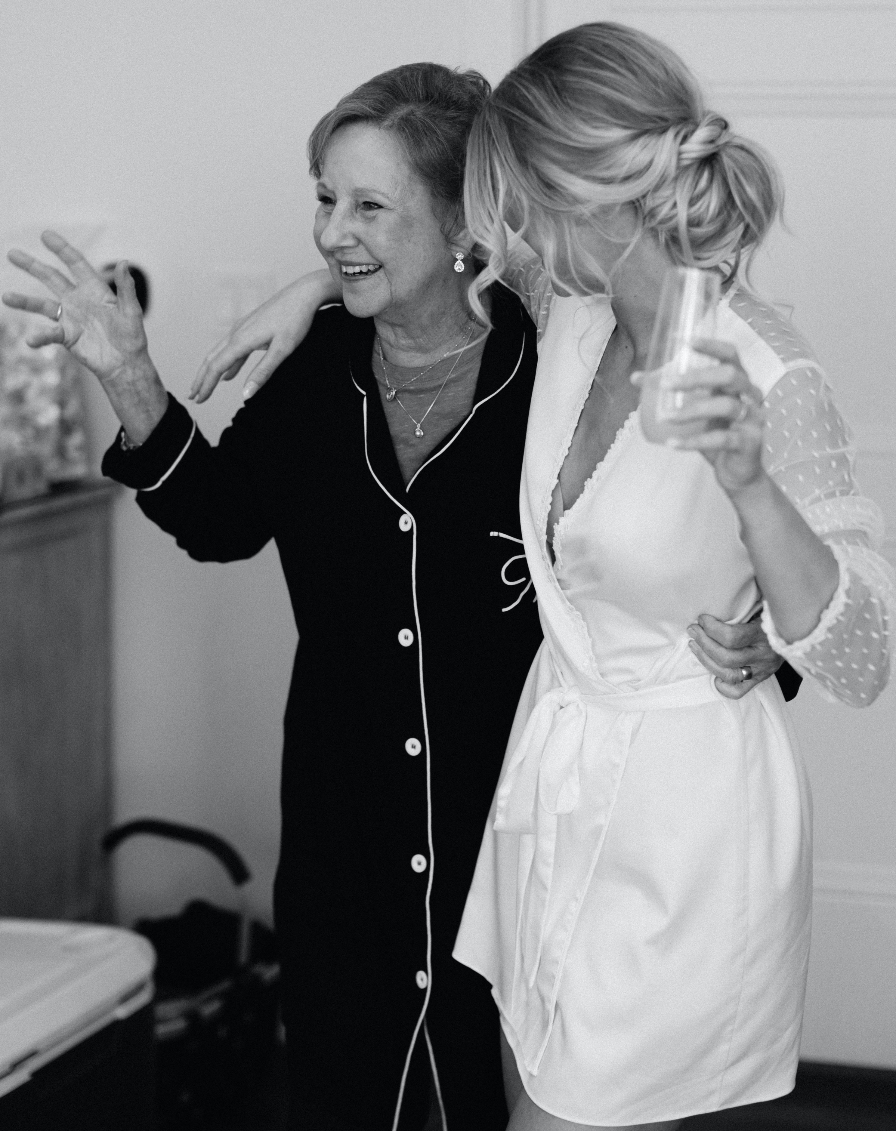 A bride dances with her grandma while they are in their robes getting ready for her wedding day in Brenham, TX.