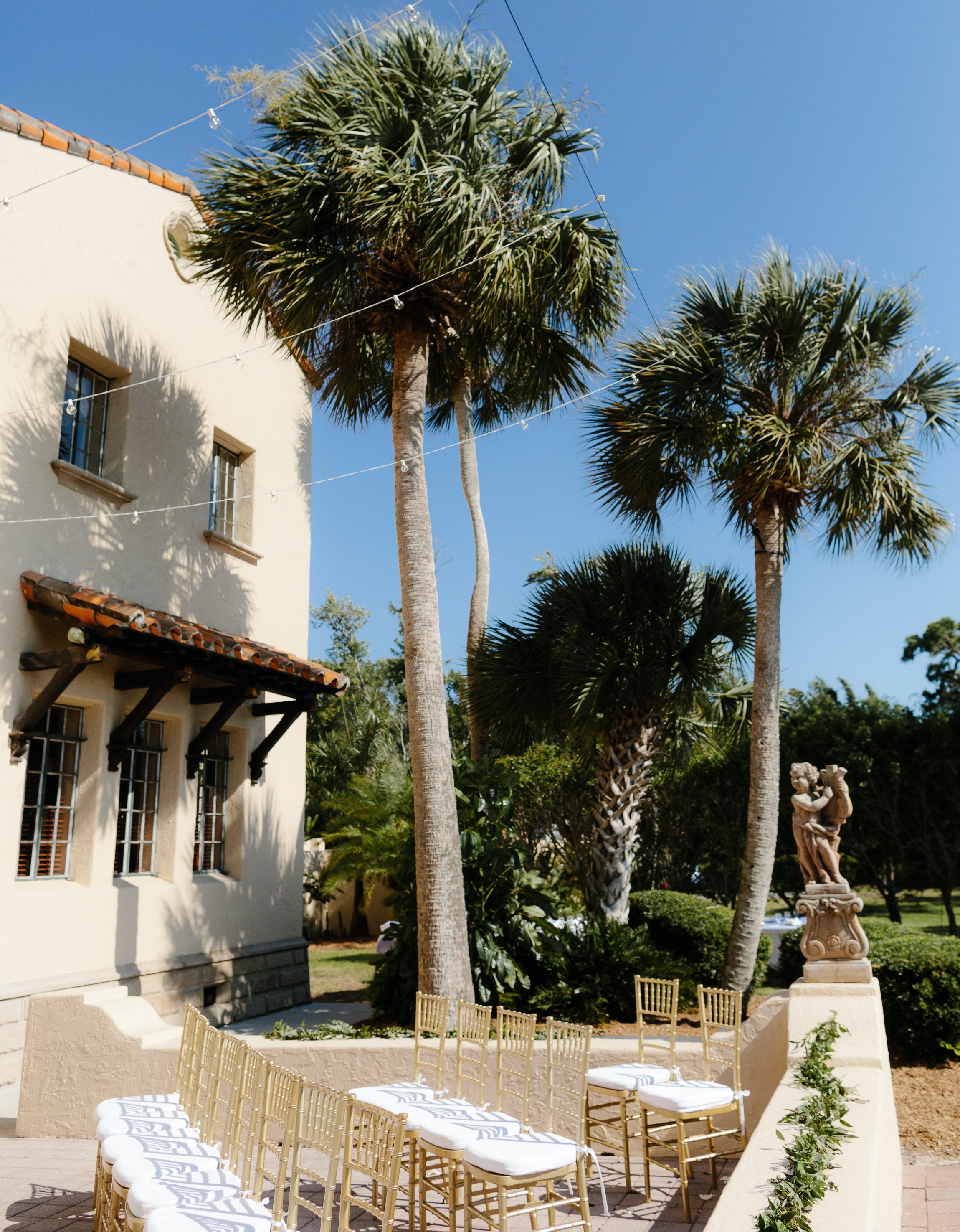 An intimate alfresco summer wedding is set up outside a wedding venue in Sarasota, FL. 