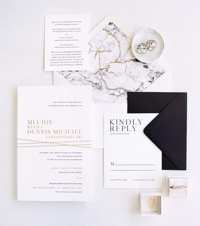 Invitation suite with gold, white and grey marble inspired envelope liner, gold letterpress font and solid black response envelope by Crane & Palette. 